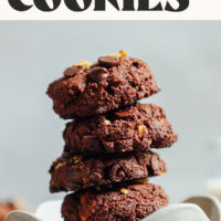Stack of fudgy vegan brownie cookies in a bowl with text above that says made with almond flour