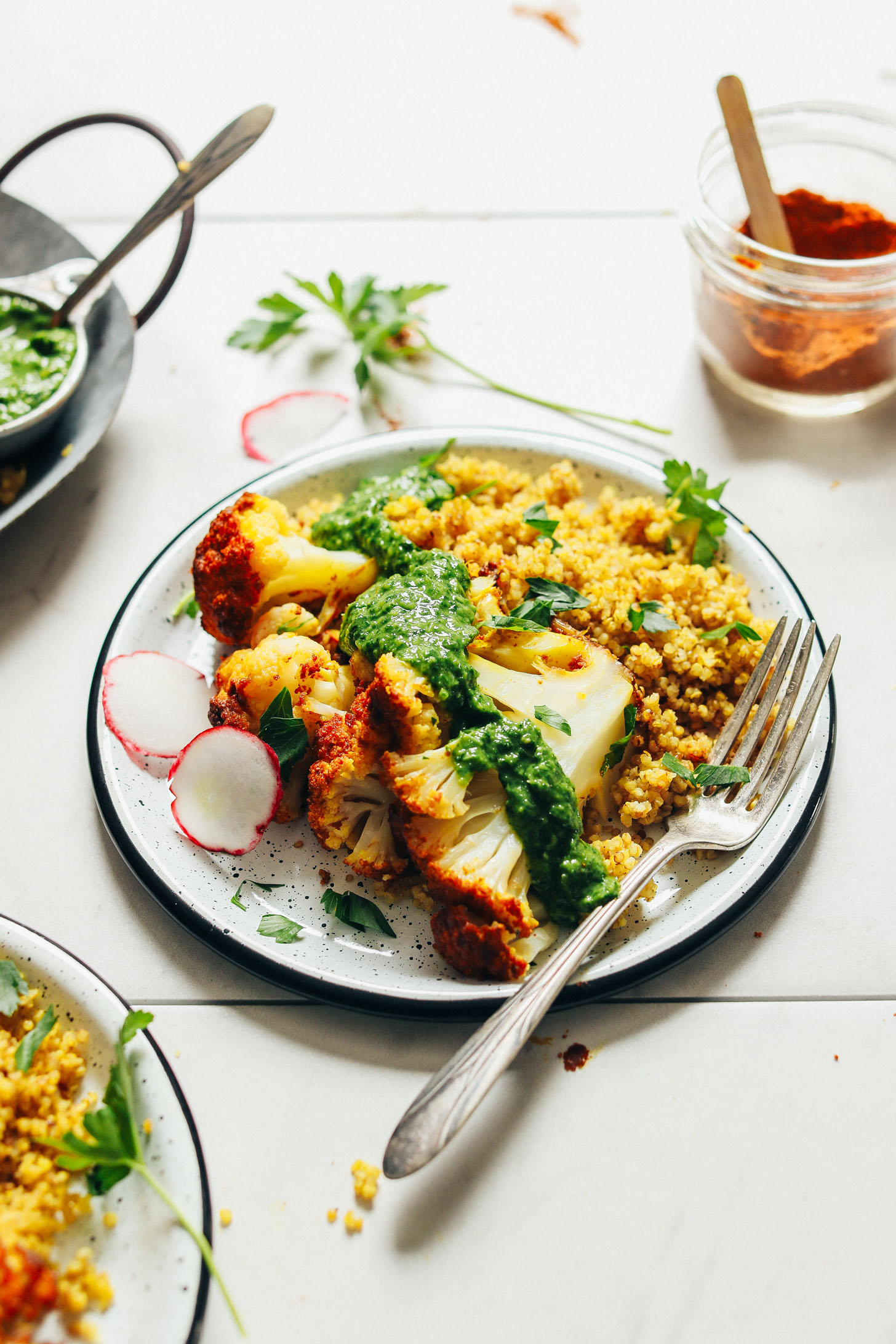 Gluten-free vegan dinner of florets of our Perfect Whole Roasted Cauliflower served with quinoa and chimichurri