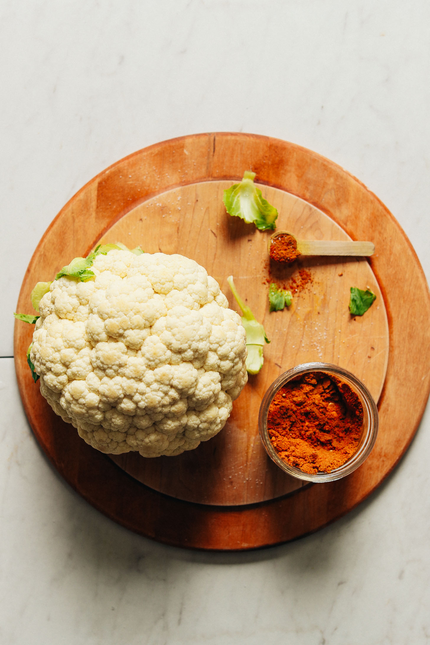 Wood cutting board with cauliflower and homemade Shawarma spice