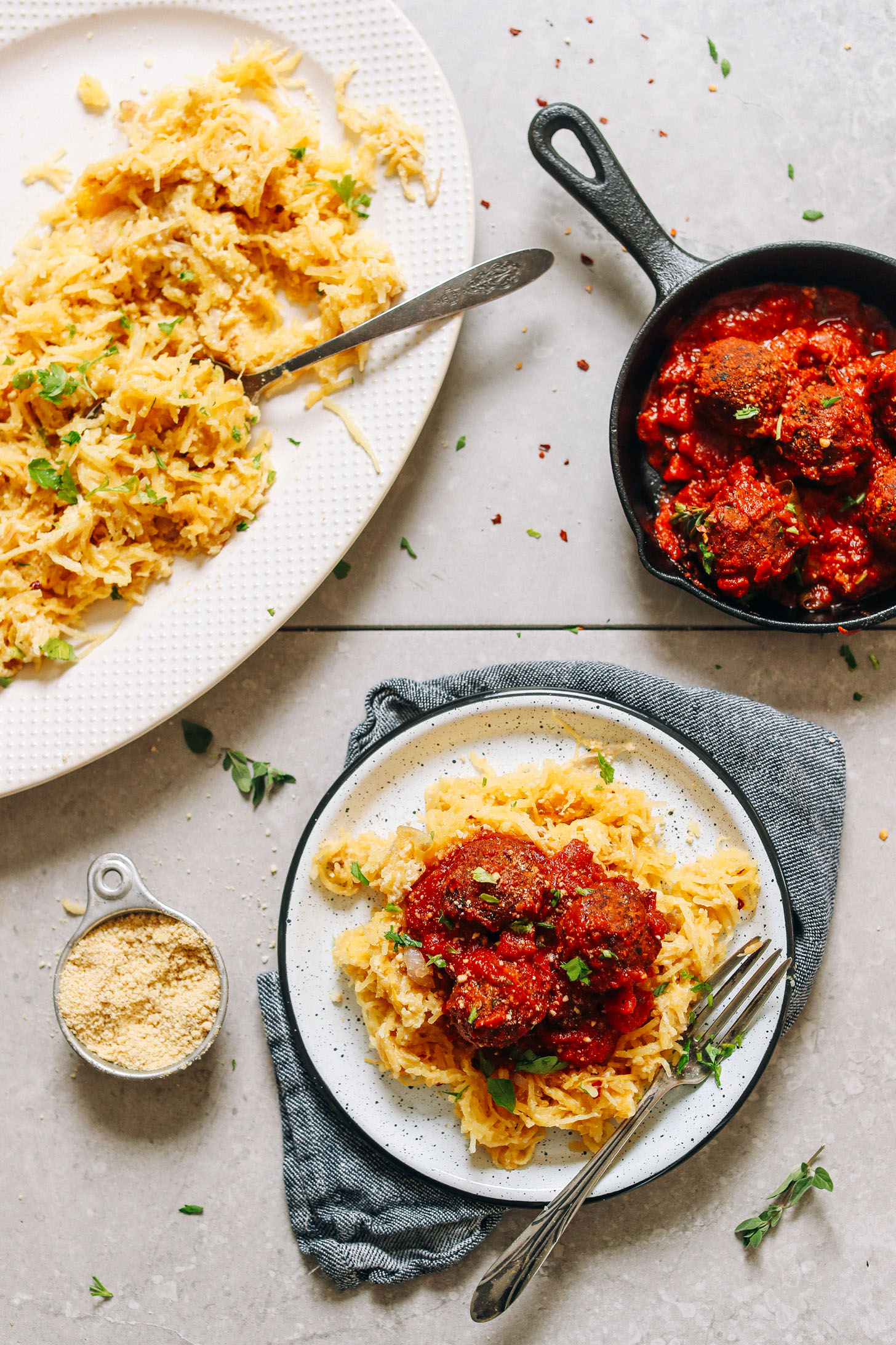 Gluten-free vegan Cheesy Spaghetti Squash Pasta topped with vegan meatballs and parmesan