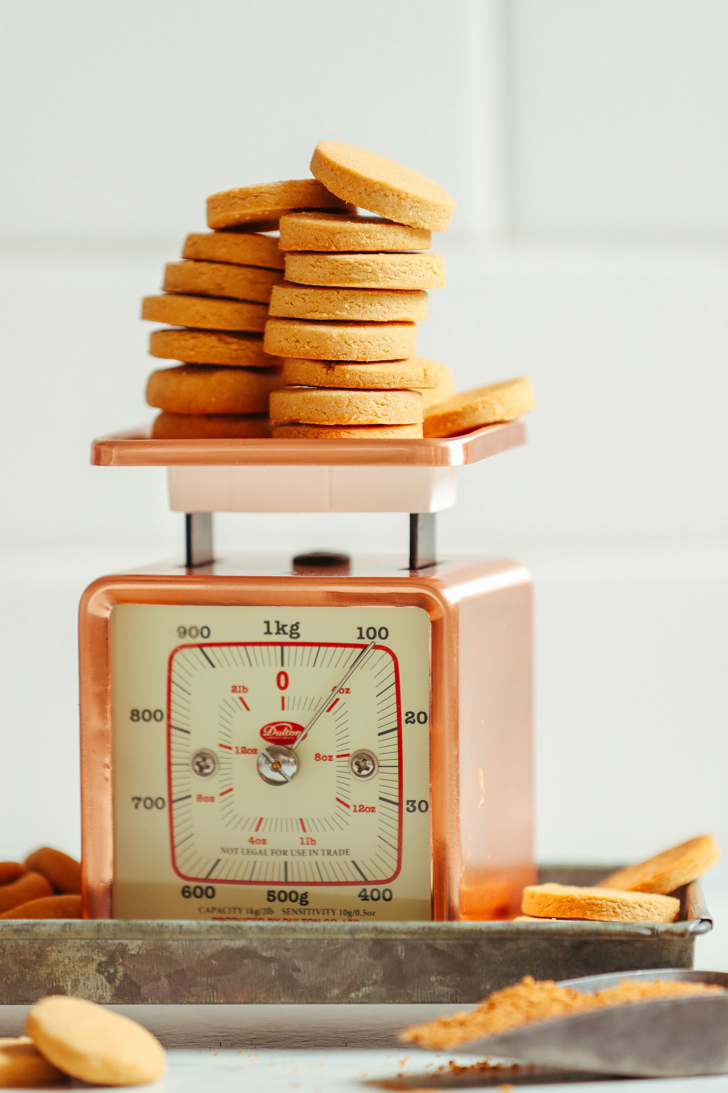 Stacks of sweet and crisp Vegan Gluten Free Vanilla Wafers perched on a vintage scale