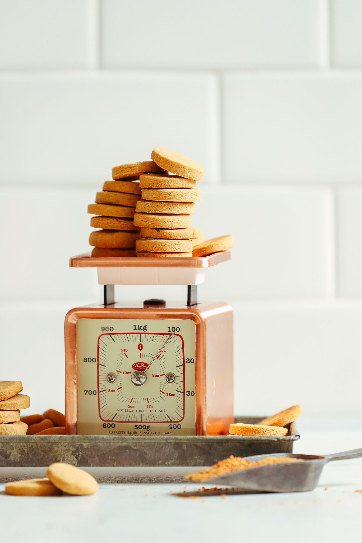 Perfectly sweet and crisp Gluten Free Vanilla Wafers resting on a vintage scale
