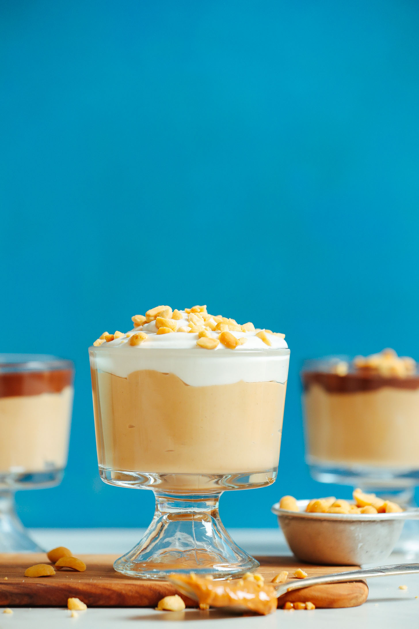 Dessert dishes filled with our Vegan Peanut Butter Pudding topped with chopped peanuts