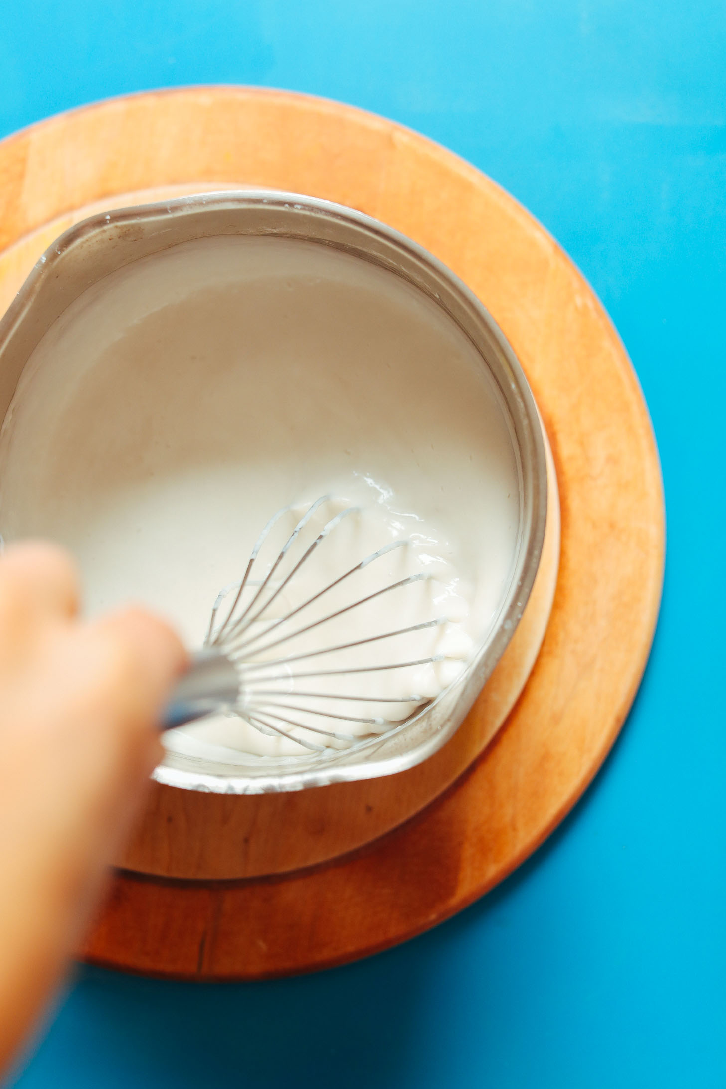 Whisking together ingredients for simple homemade vegan pudding