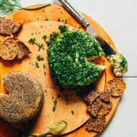 Cultured Vegan Cheese Wheels on a wood cutting board