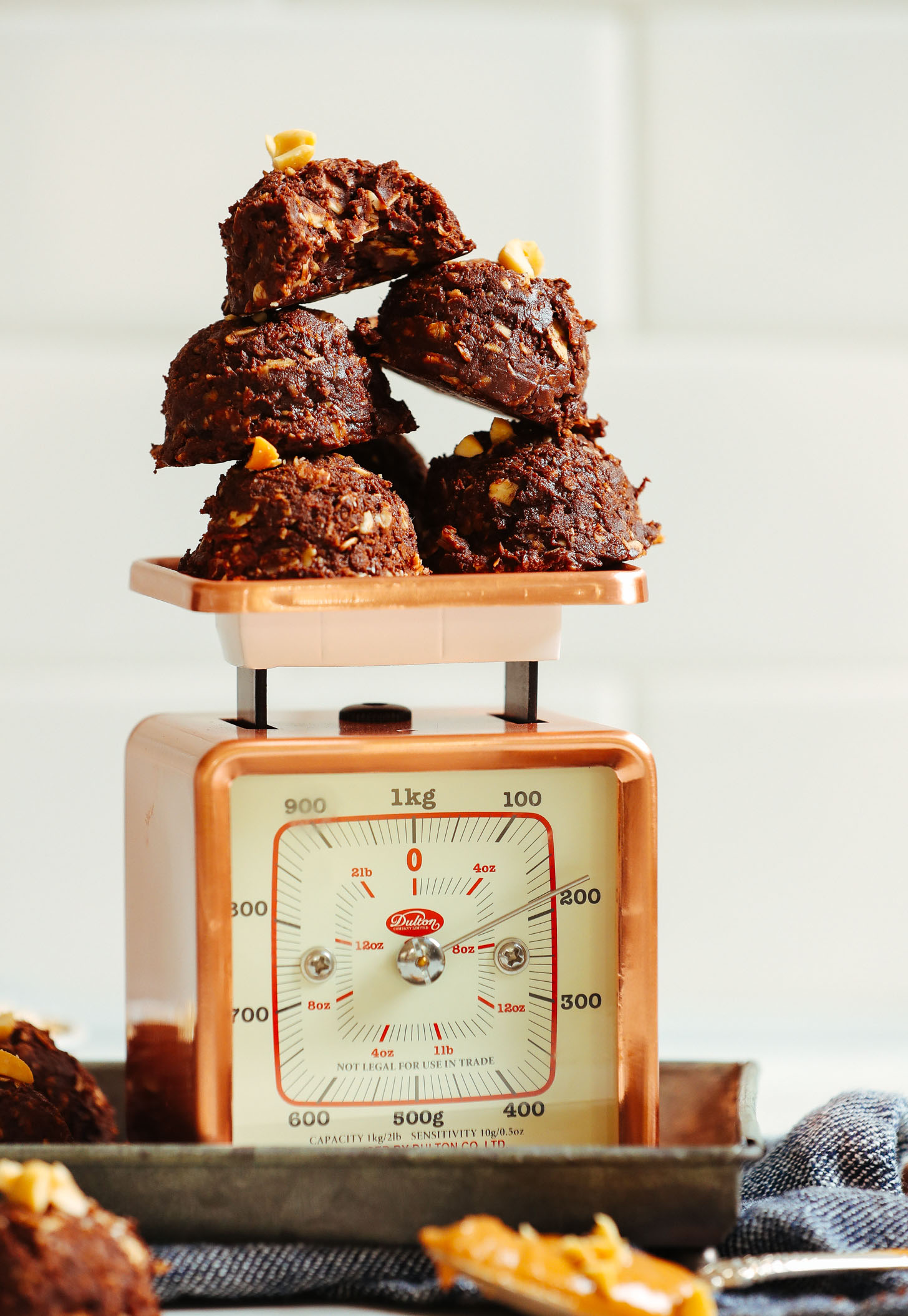 Stack of Vegan Peanut Butter No Bake Cookies perched upon a scale