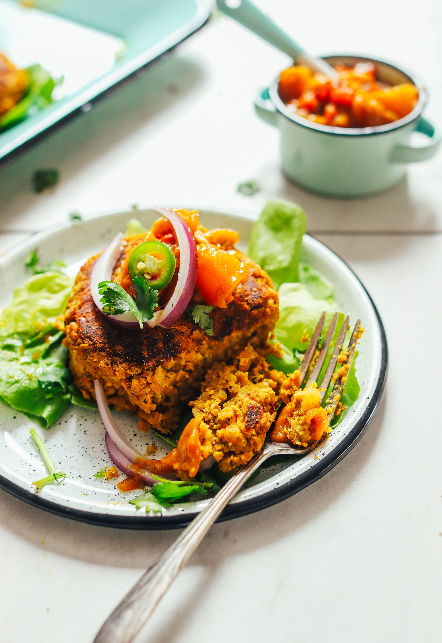 Grabbing a bite of our homemade Curried Chickpea Burger with mango chutney