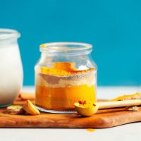 Jar of Golden Milk Mix with the spices arranged in layers