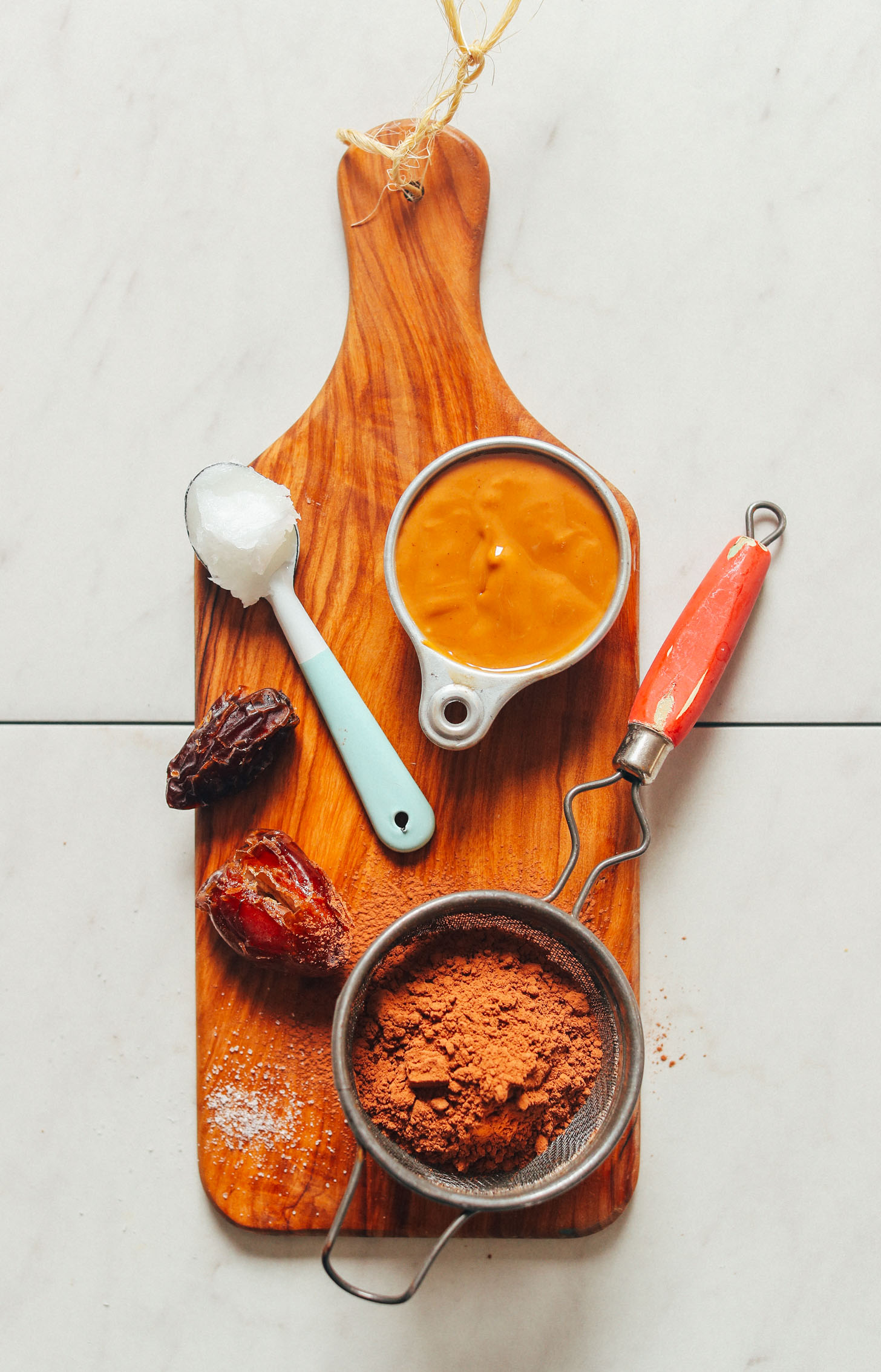 Dates, coconut oil, peanut butter, and cacao powder for making homemade vegan fudge