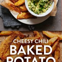 Baking sheet and platter of Crispy Baked Oil-Free Potato Fries with a bowl of guacamole