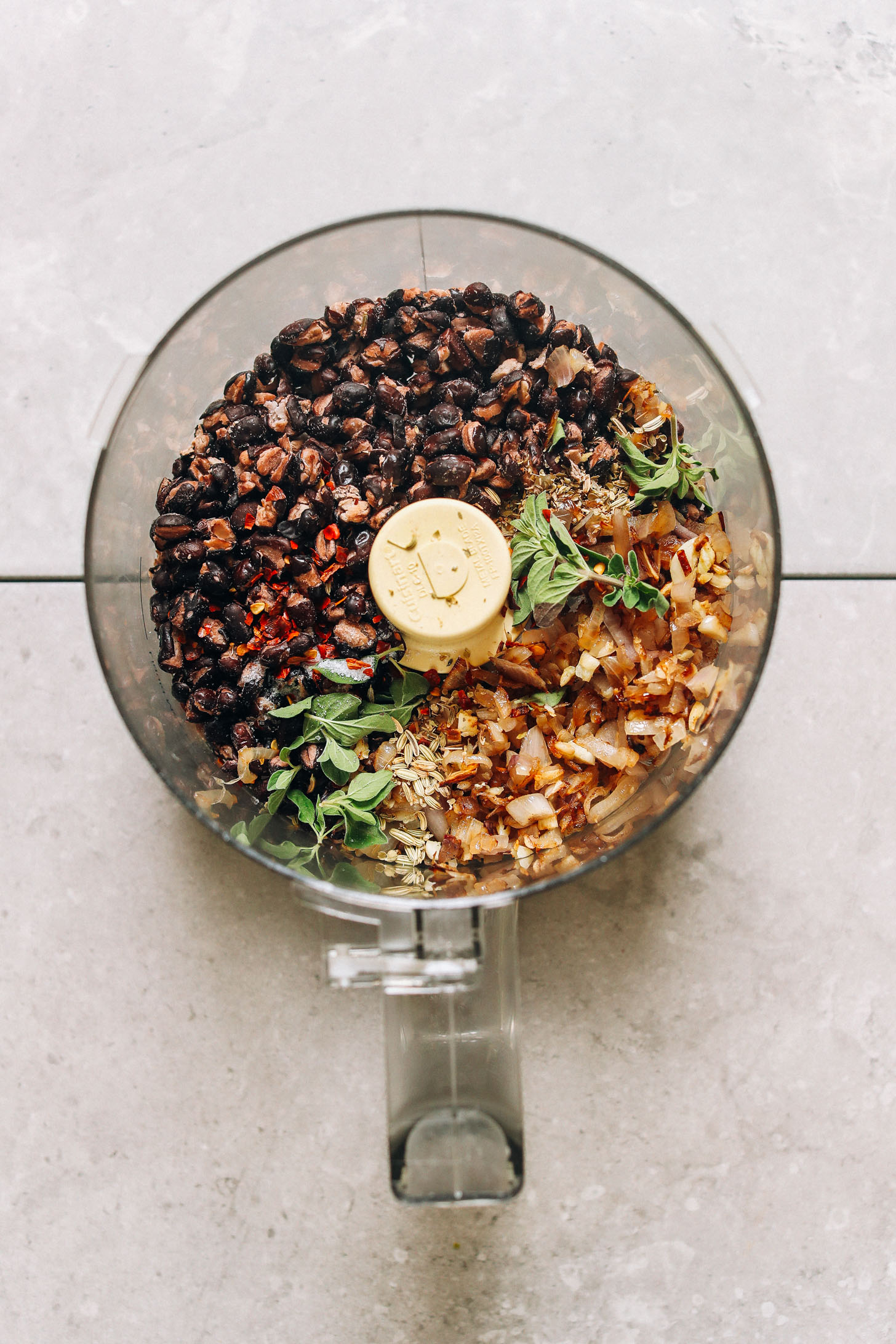 Blender filled with ingredients for making perfect vegan meatballs