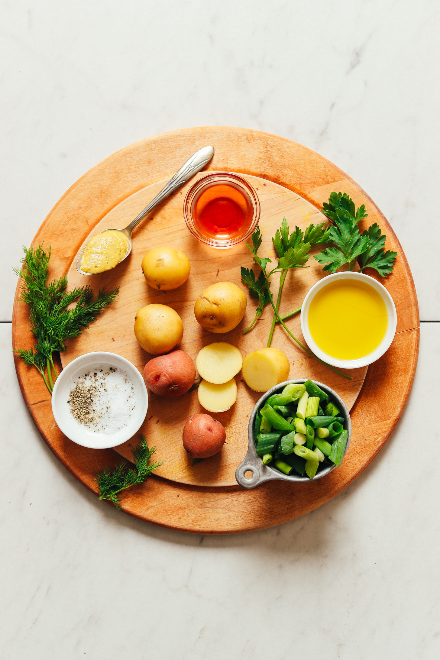 Cutting board filled with ingredients for making homemade French-Style Potato Salad