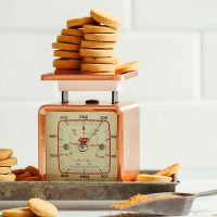 Batch of Vegan Vanilla Wafer Cookies resting on a vintage scale