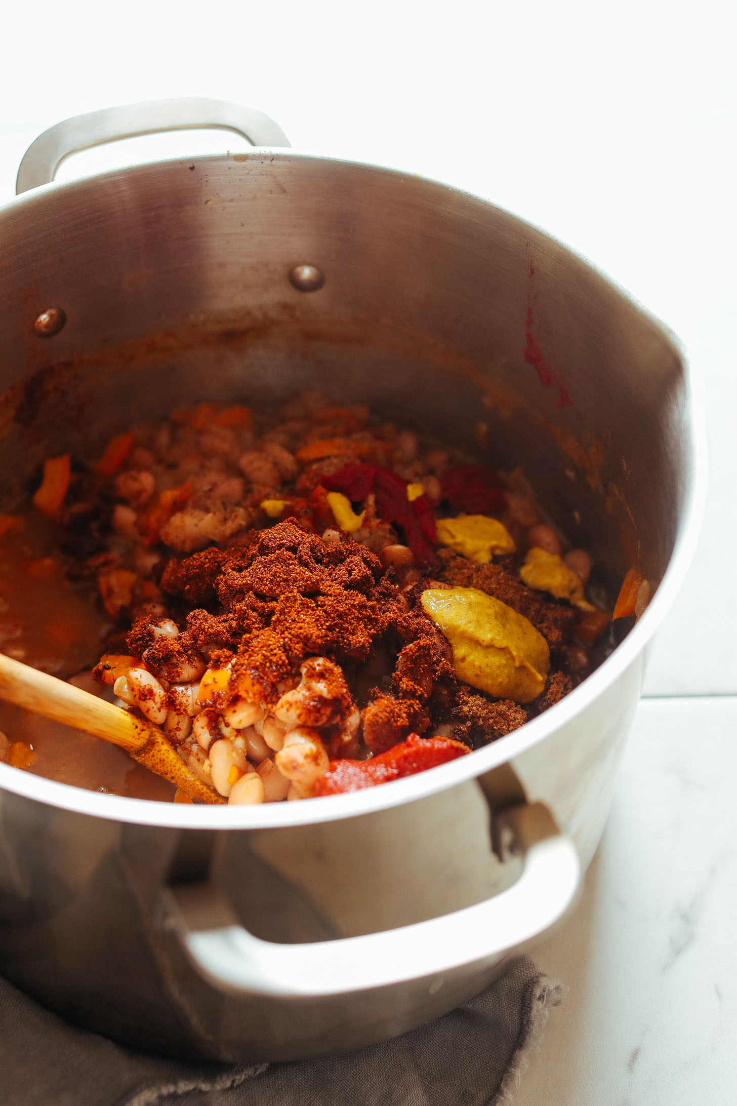 Adding spices our flavorful vegan BBQ Baked Beans recipe