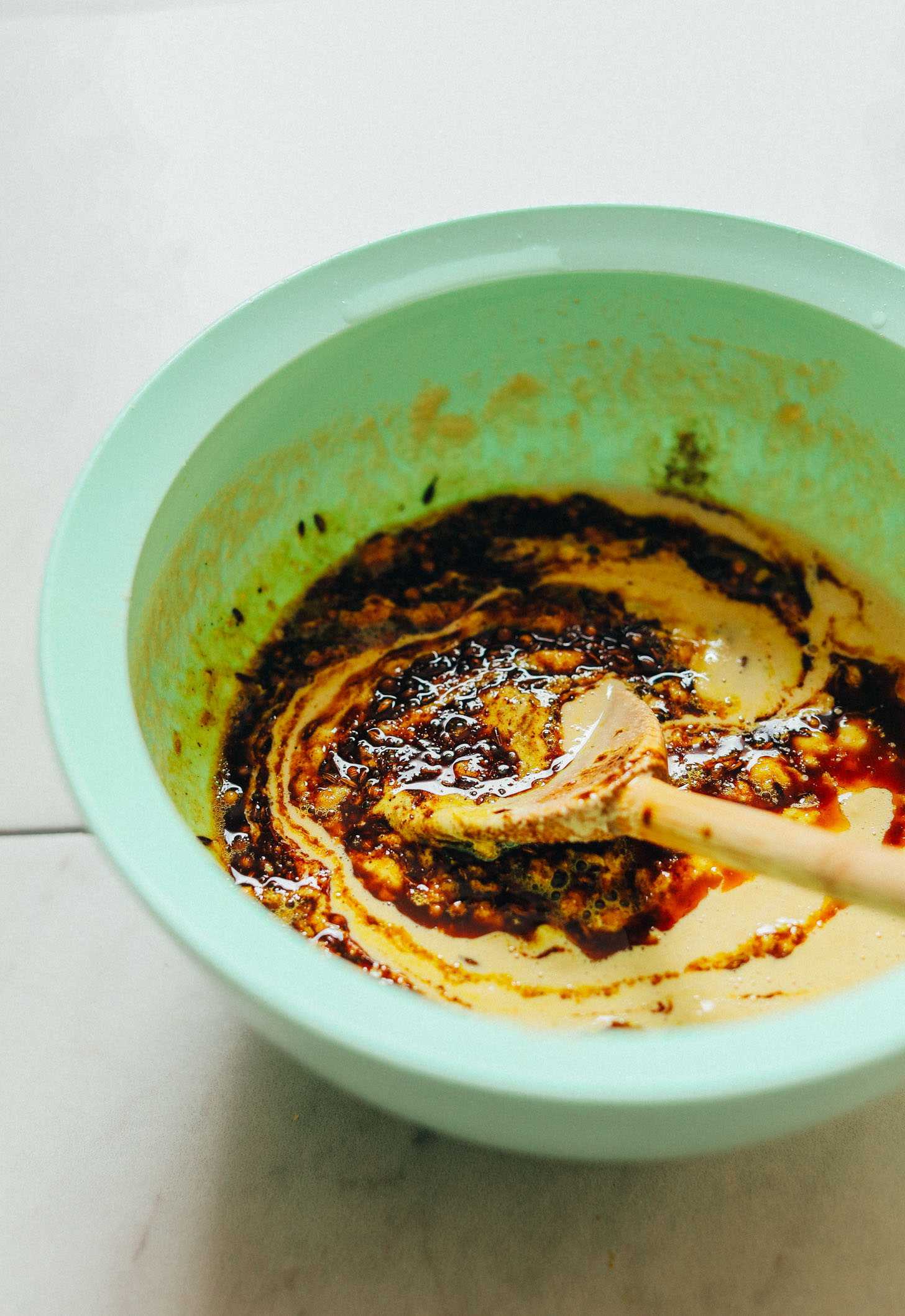 Stirring together ingredients for our fluffy vegan Curried Socca recipe 