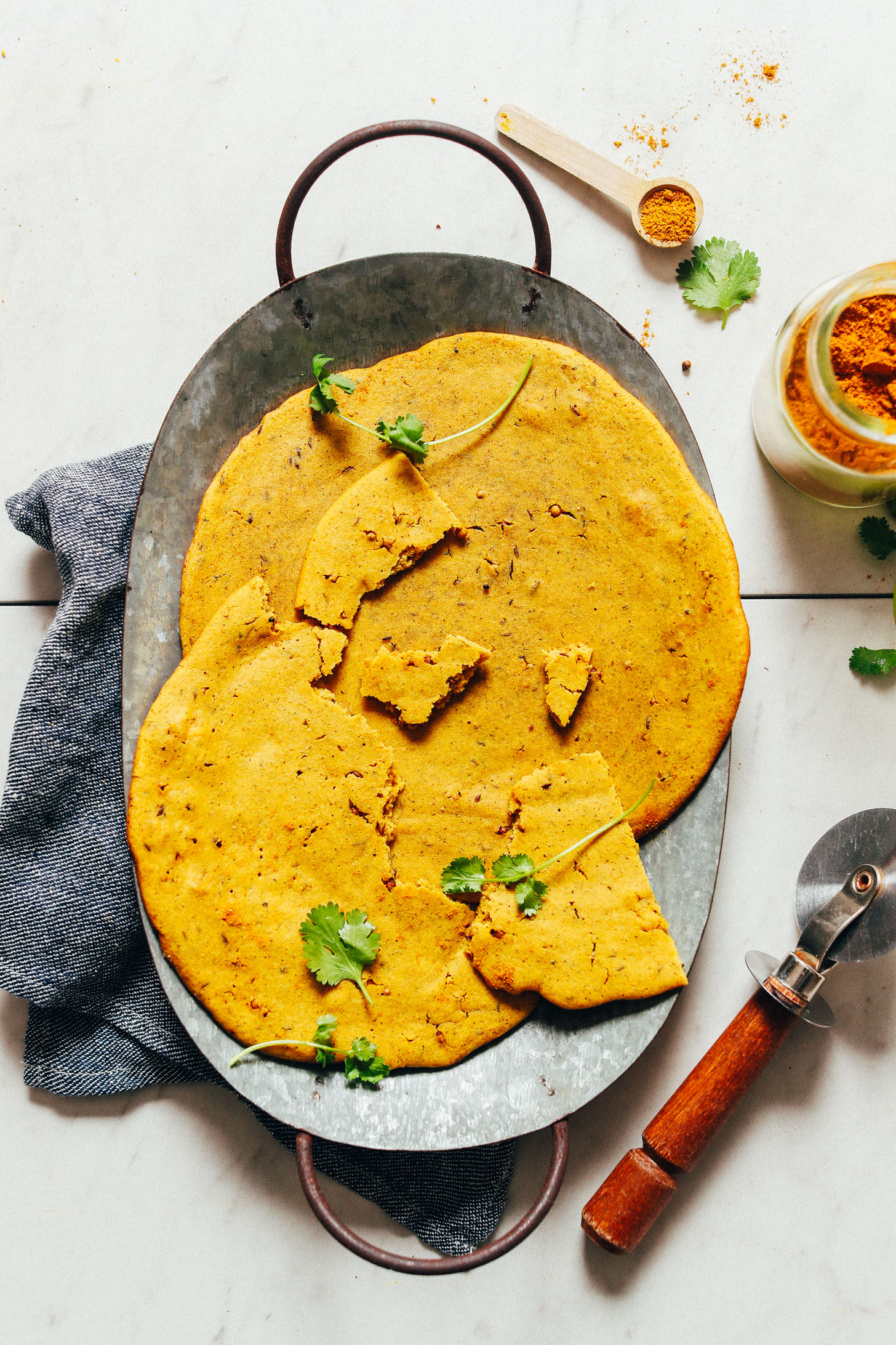 Tray filled with fresh vegan Curried Socca bread
