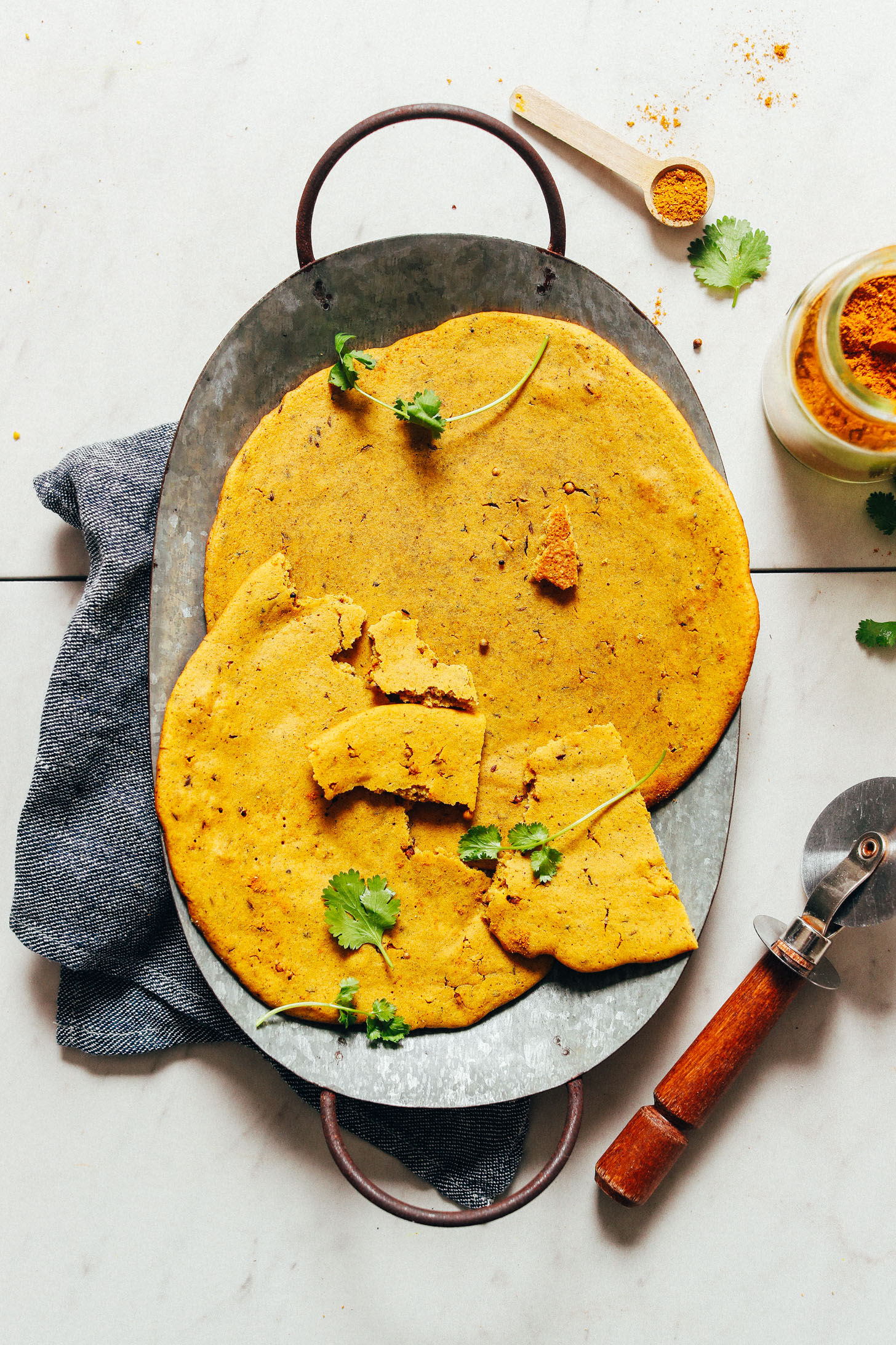 Pieces of vegan Curried Socca bread on a tray