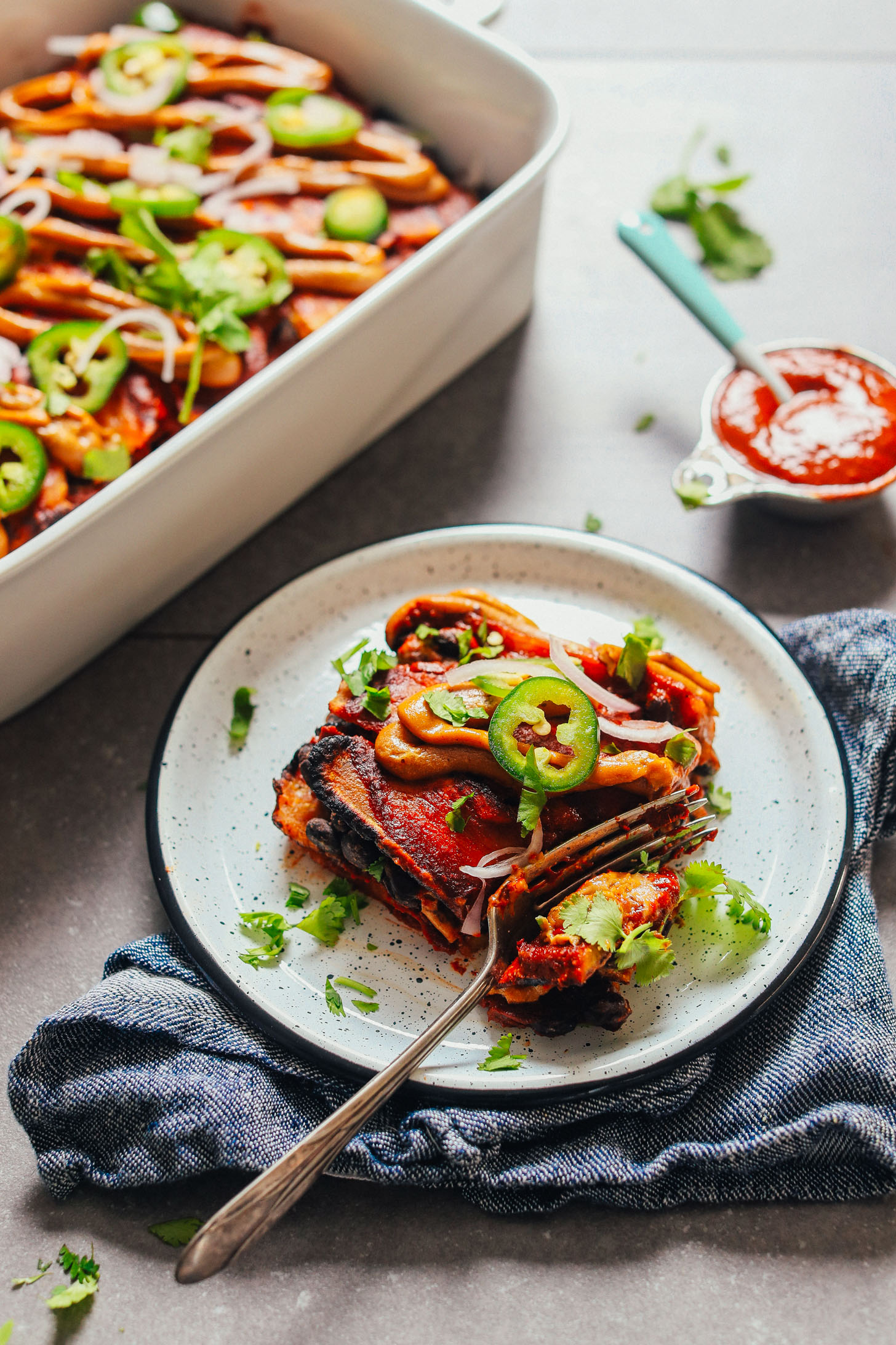 Using a fork to grab a bite of our Plantain Black Bean Enchilada Bake recipe