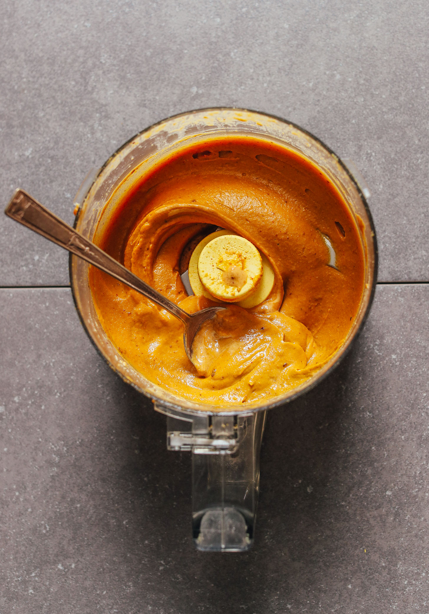 Food processor filled with freshly made vegan queso