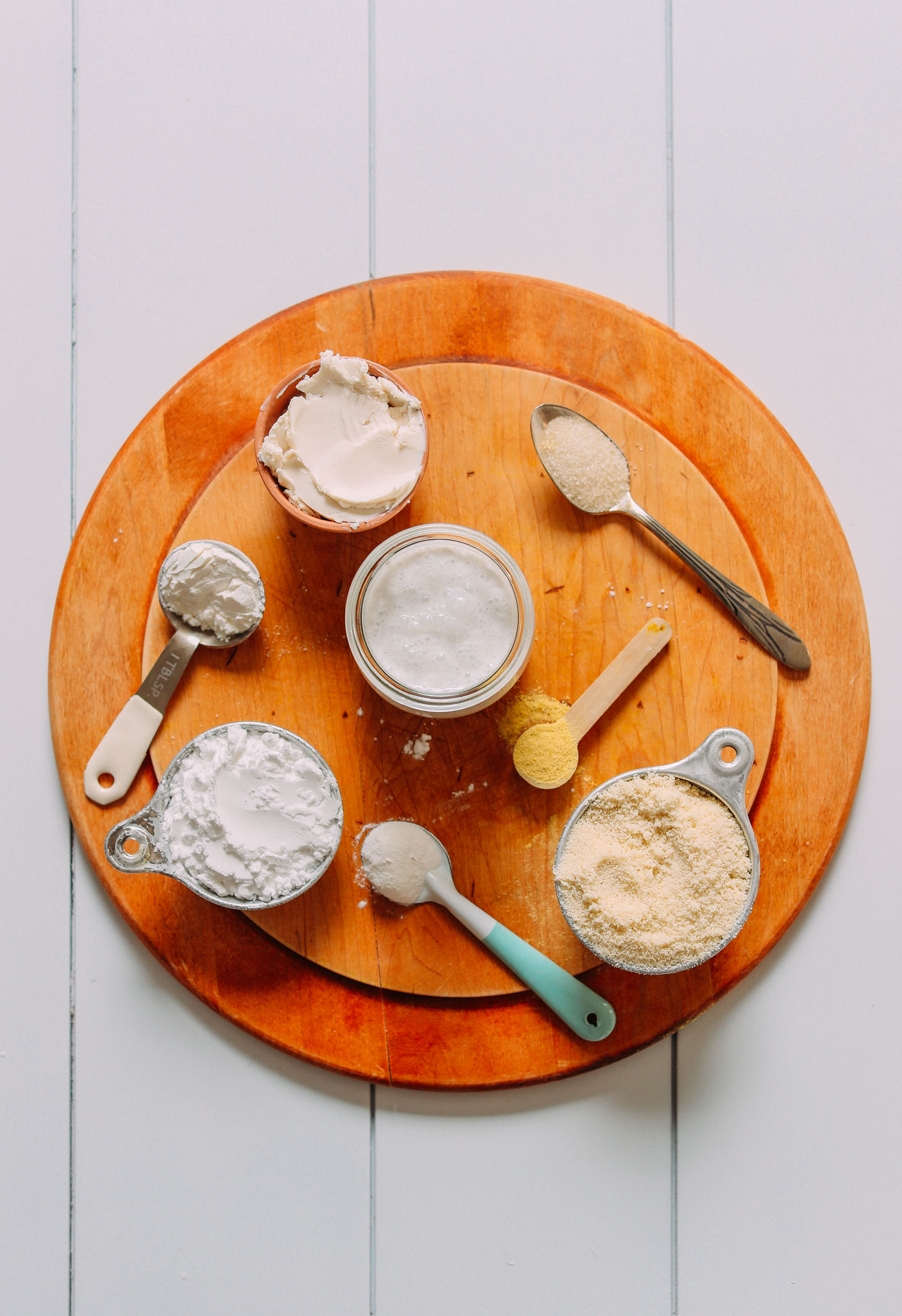 Wood cutting board filled with ingredients for making our homemade Vegan Gluten-Free Biscuits