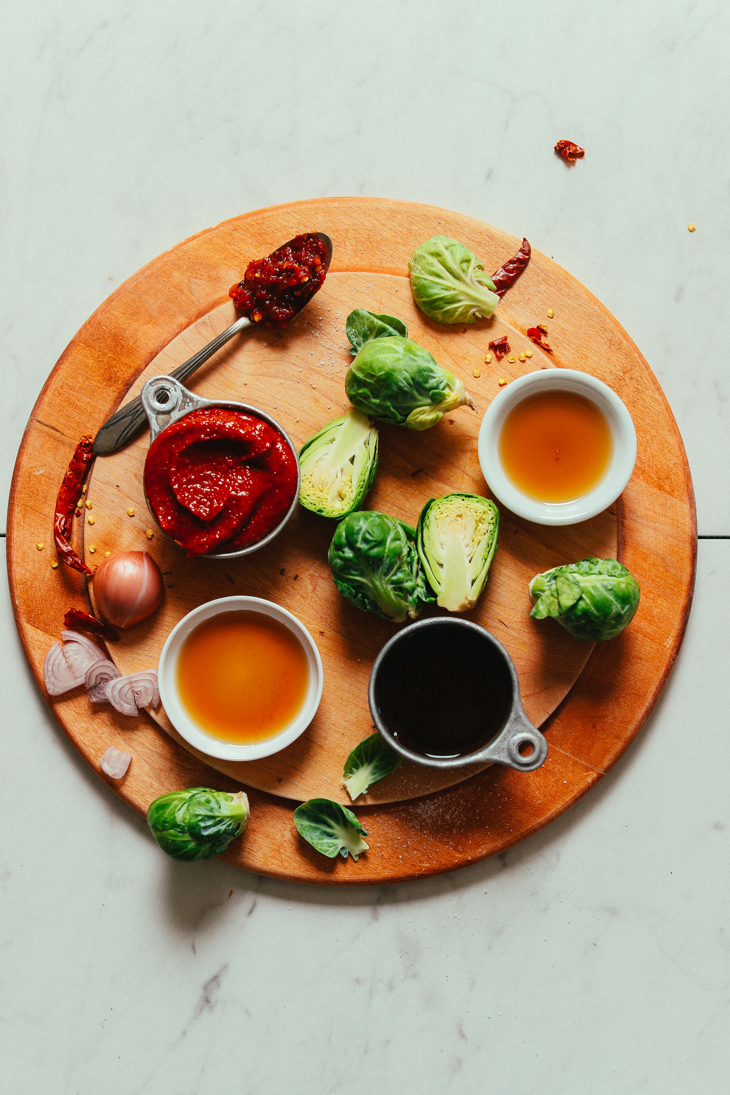 Cutting board with ingredients for making our vegan Gochujang Stir-Fried Brussels Sprouts