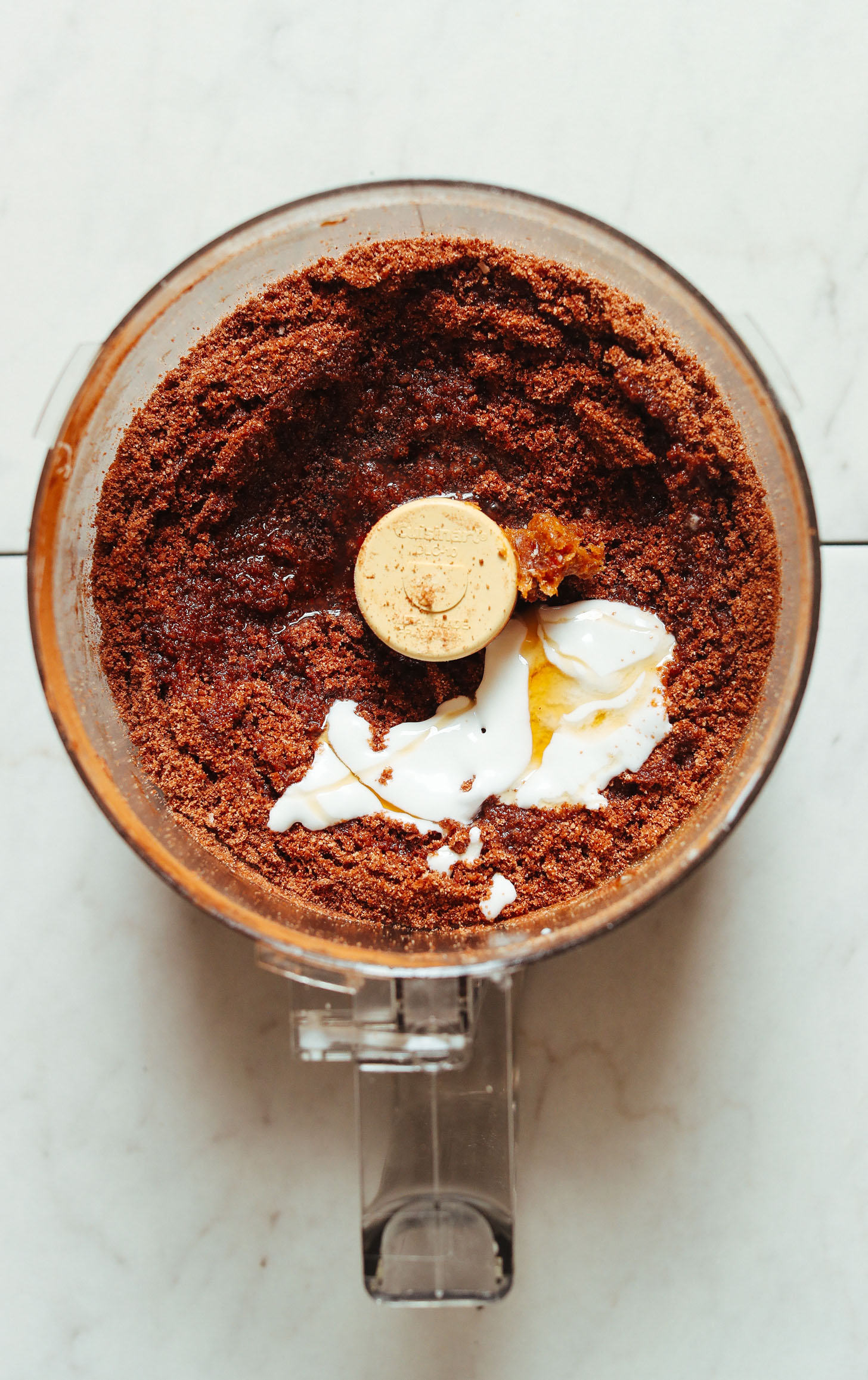 Food processor with coconut cream added to Chocolate Cake Bites batter