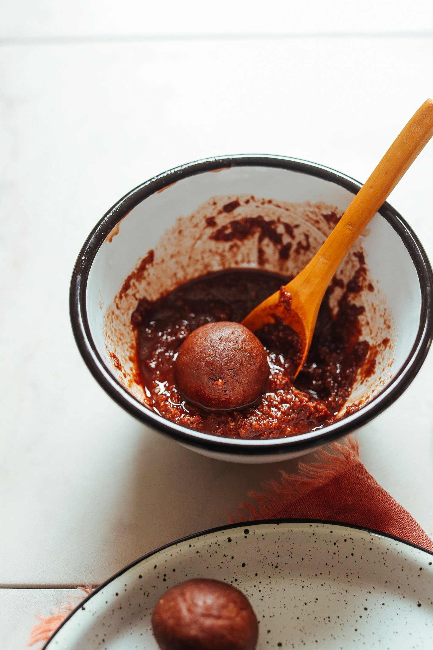 Coating Vegan Chocolate Cake Bites with chocolate glaze