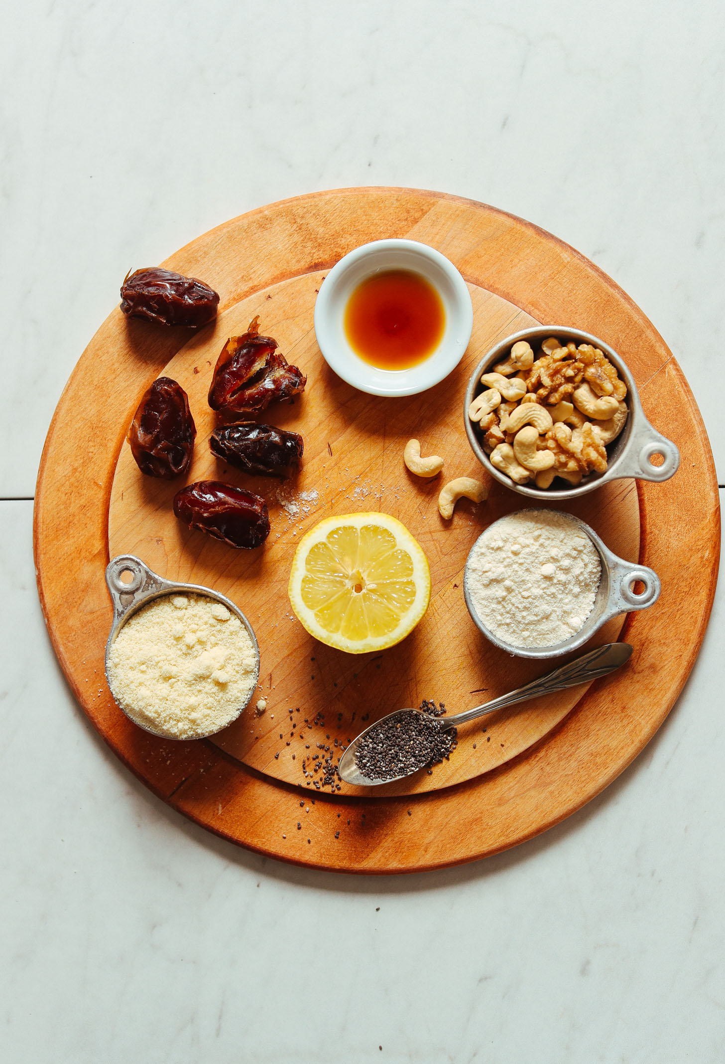 Wood cutting board with ingredients for making our Vegan Lemon Poppyseed Donut Holes recipe