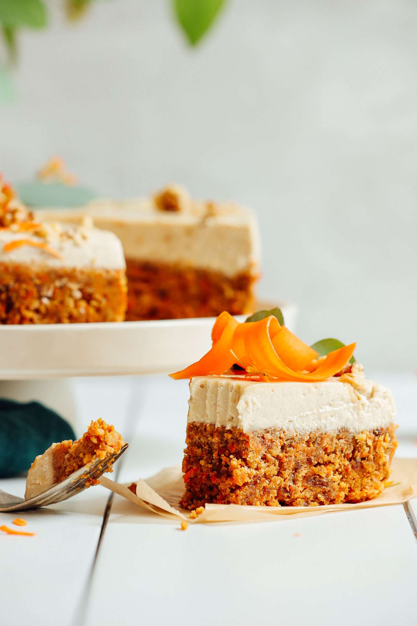 Bite removed from a slice of naturally sweetened Raw Vegan Carrot Cake