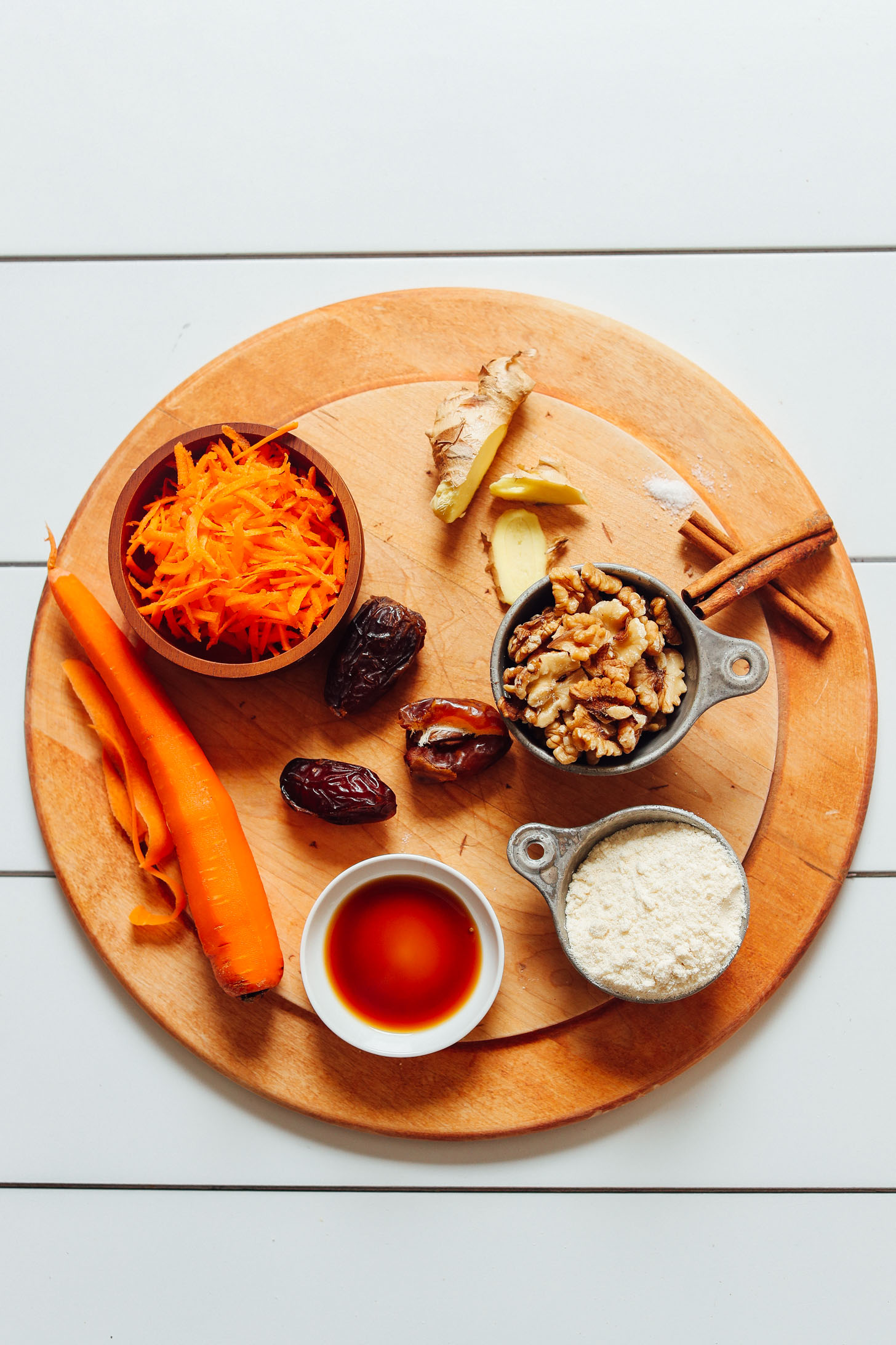 Wood cutting board with ingredients for making homemade Raw Vegan Carrot Cake