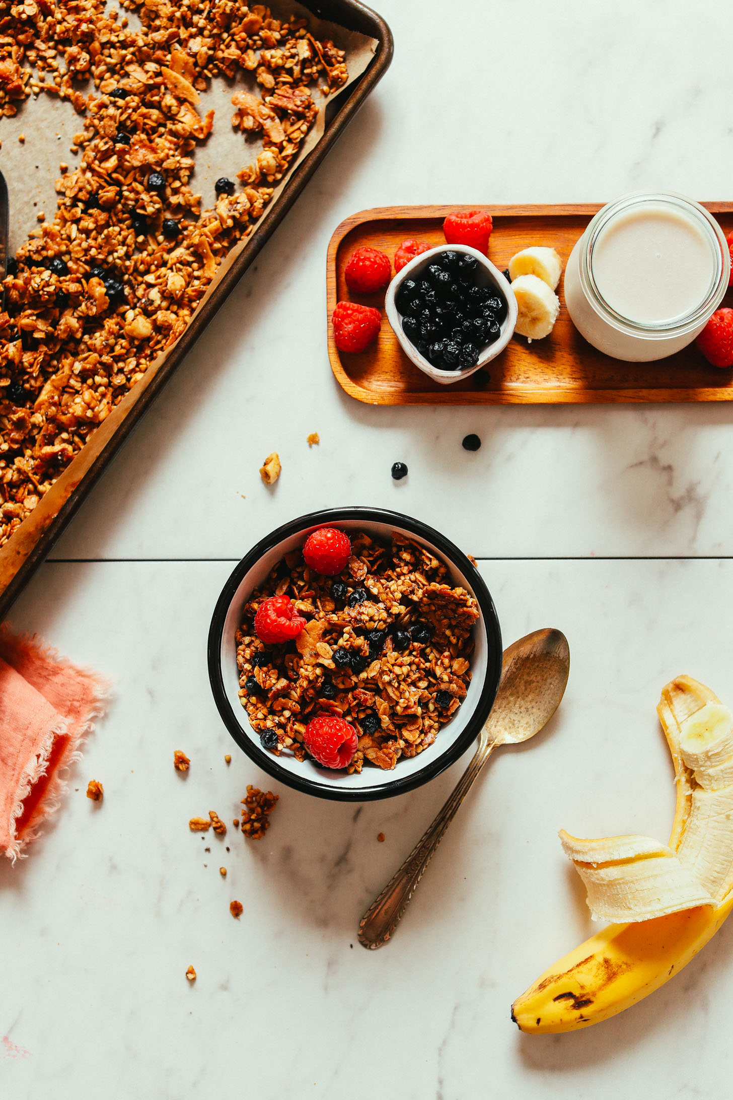 Bowl of Buckwheat Granola with berries, banana, and almond milk in the photo