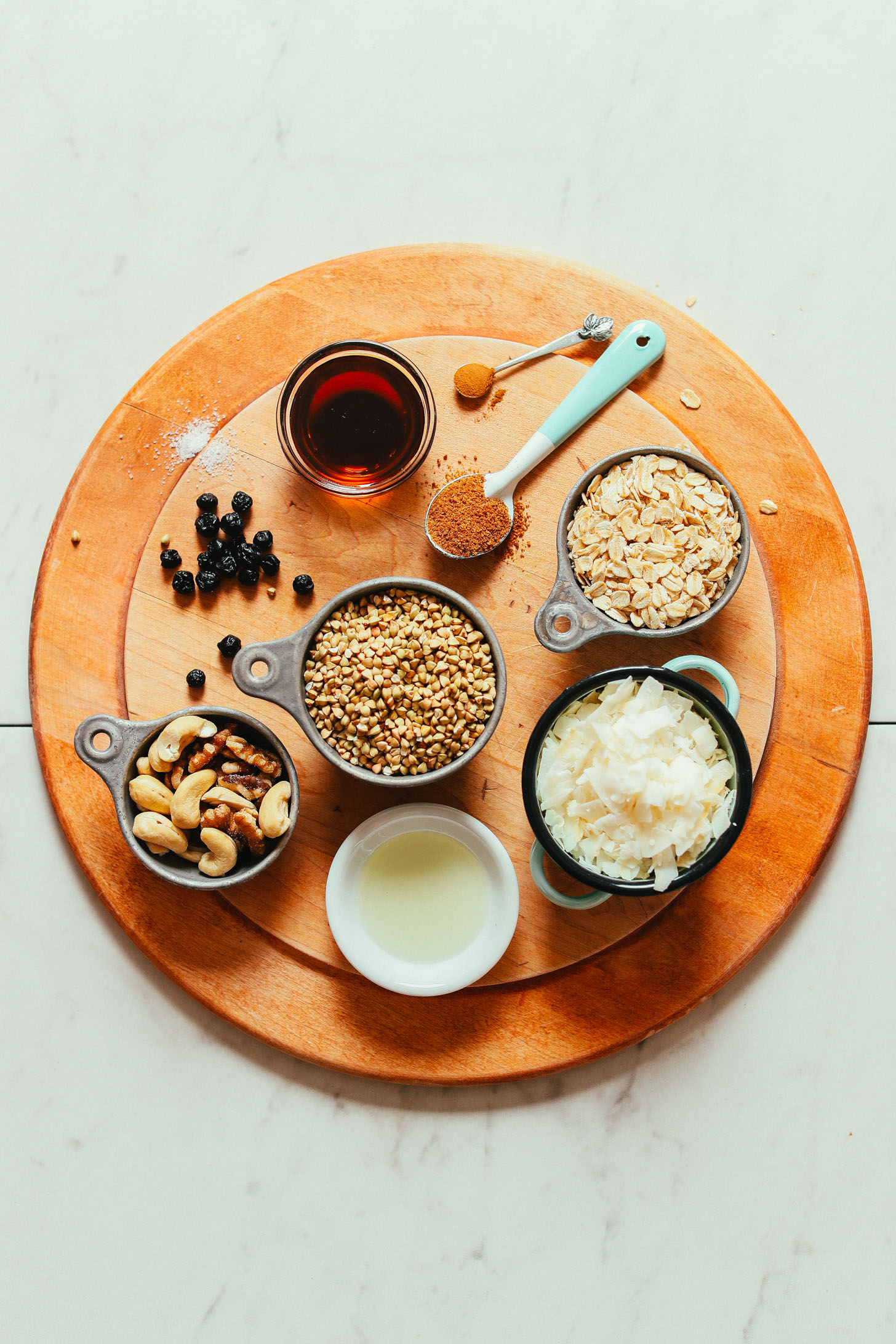 Wood board with ingredients for making gluten-free vegan Easy Buckwheat Granola