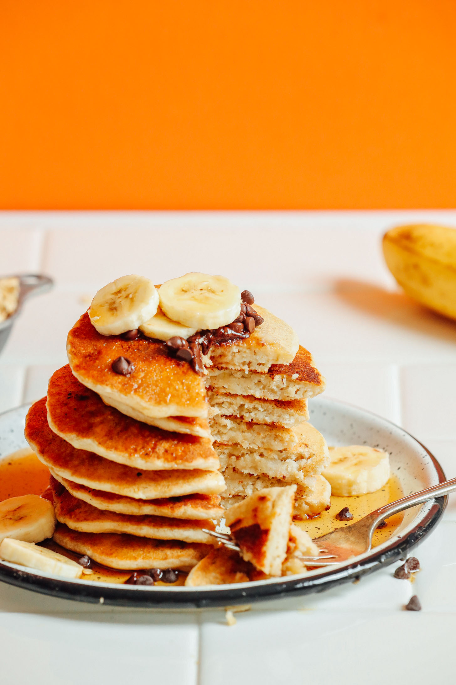 Bite removed from a stack of our delicious Banana Oat Pancakes recipe