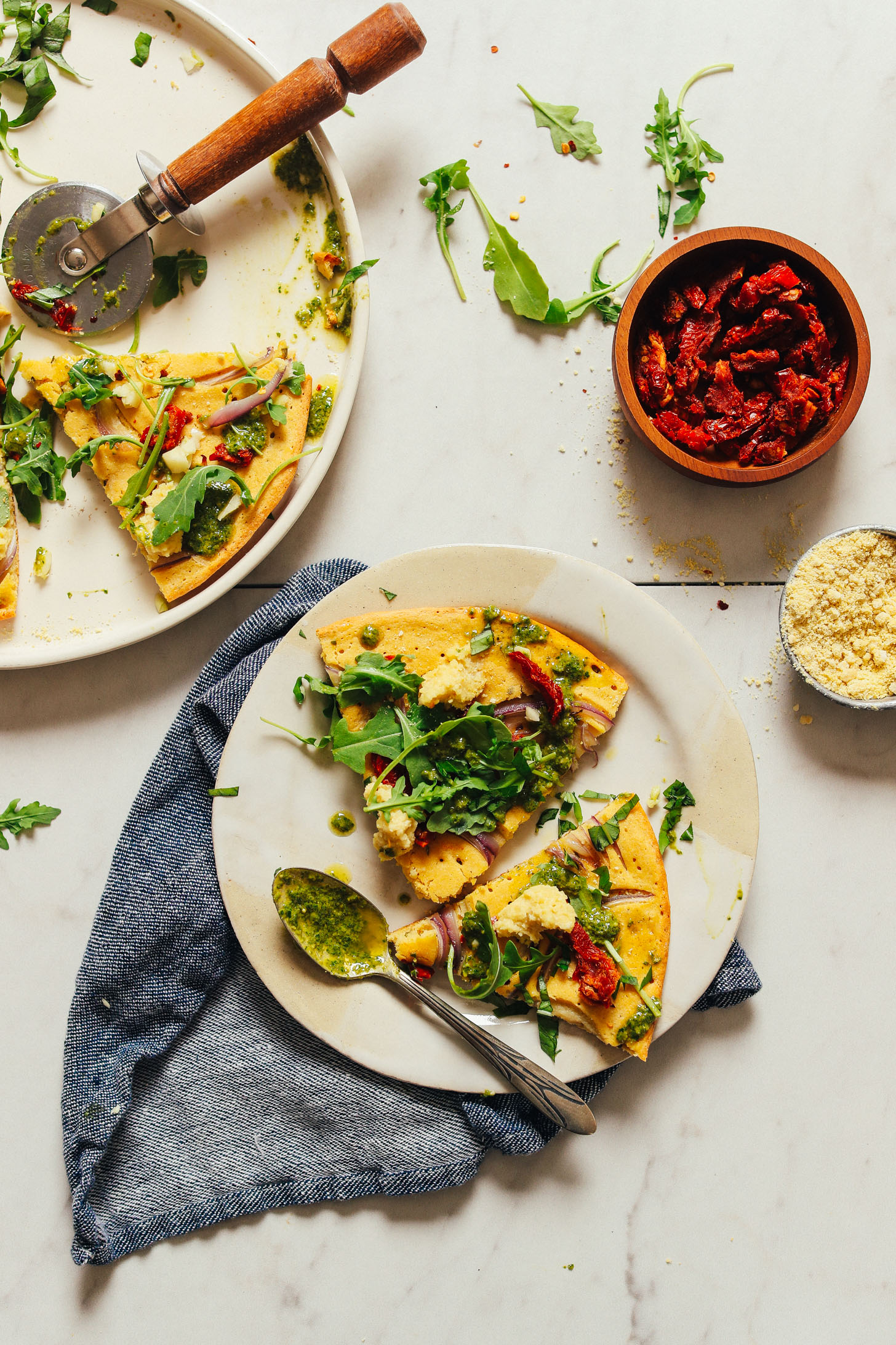 Plate with slices of our delicious Socca Pizza with Vegan Pesto