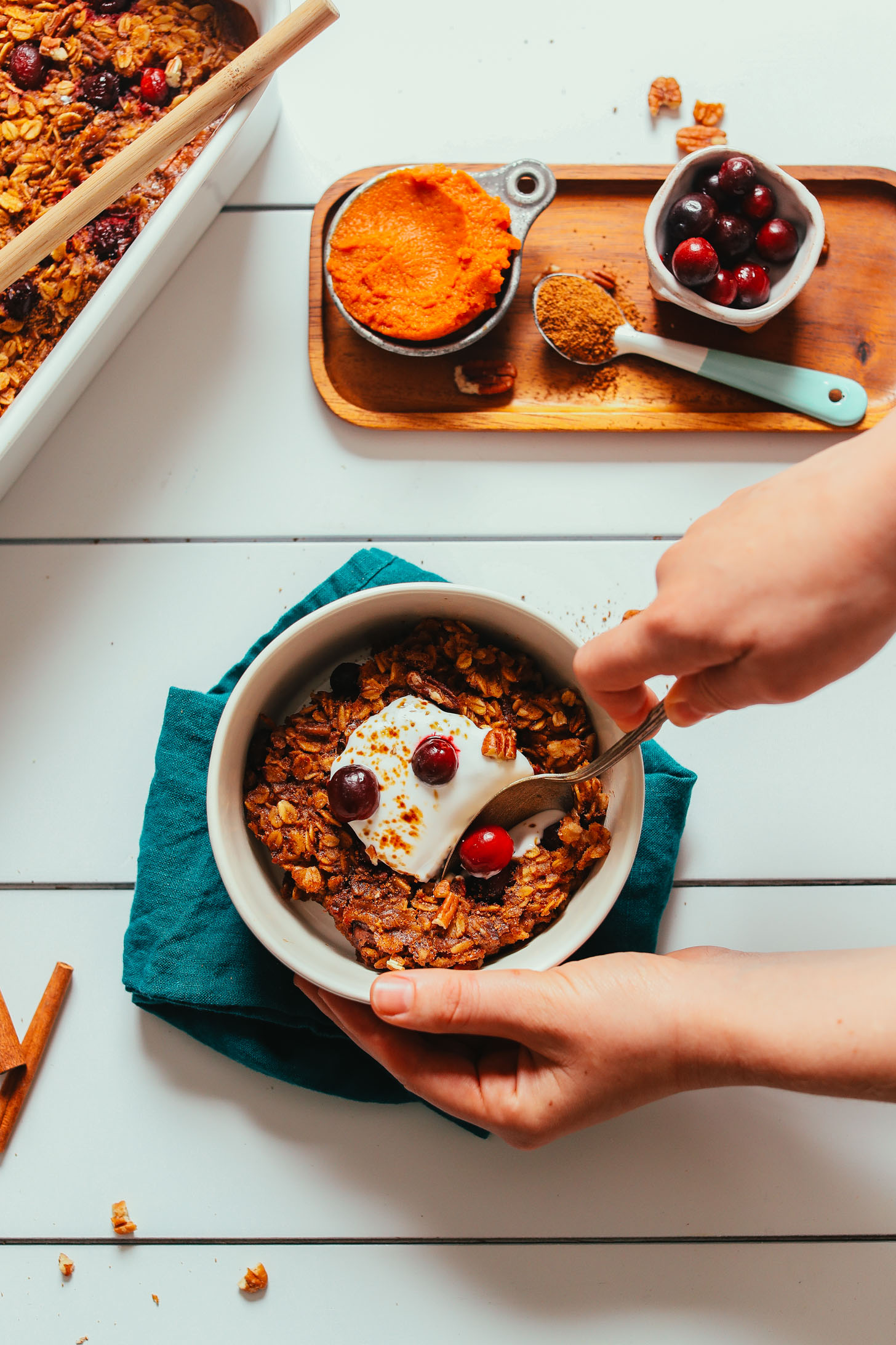 Grabbing a bite of Vegan Pumpkin Baked Oatmeal topped with coconut whip