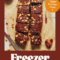 Squares of chocolate peanut butter freezer fudge on a piece of parchment paper