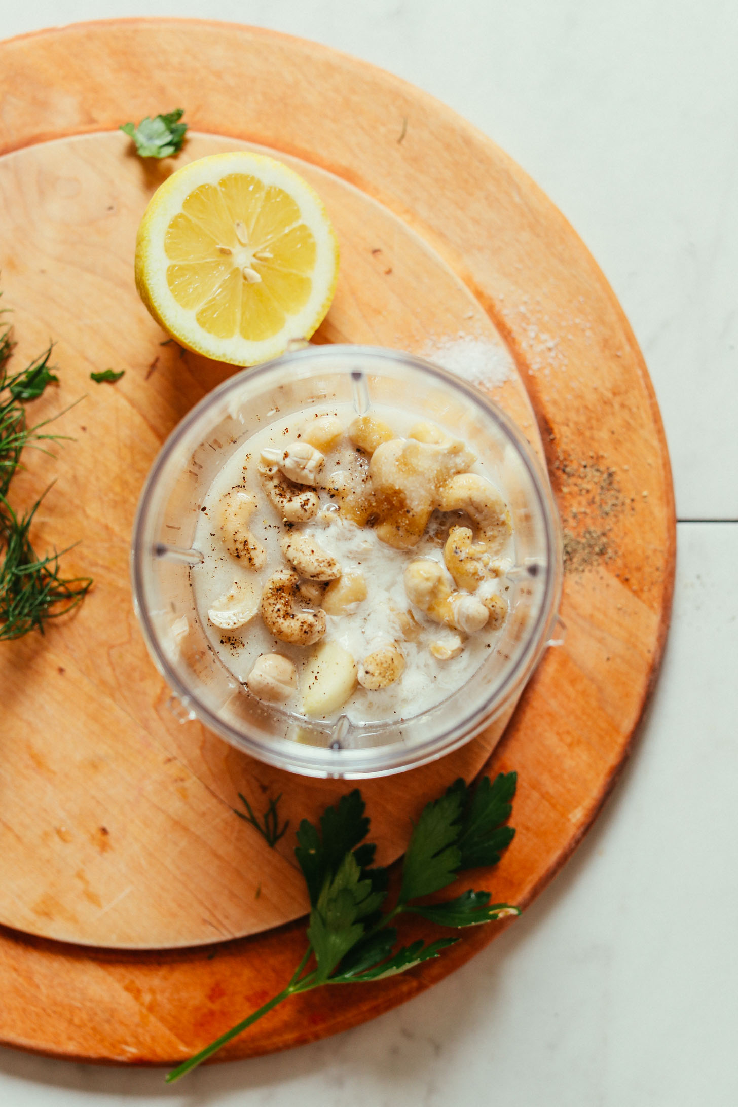 Small blender filled with ingredients for making homemade vegan ranch dressing