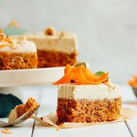 Partially eaten slice of Raw Carrot Cake resting beside the rest of the cake