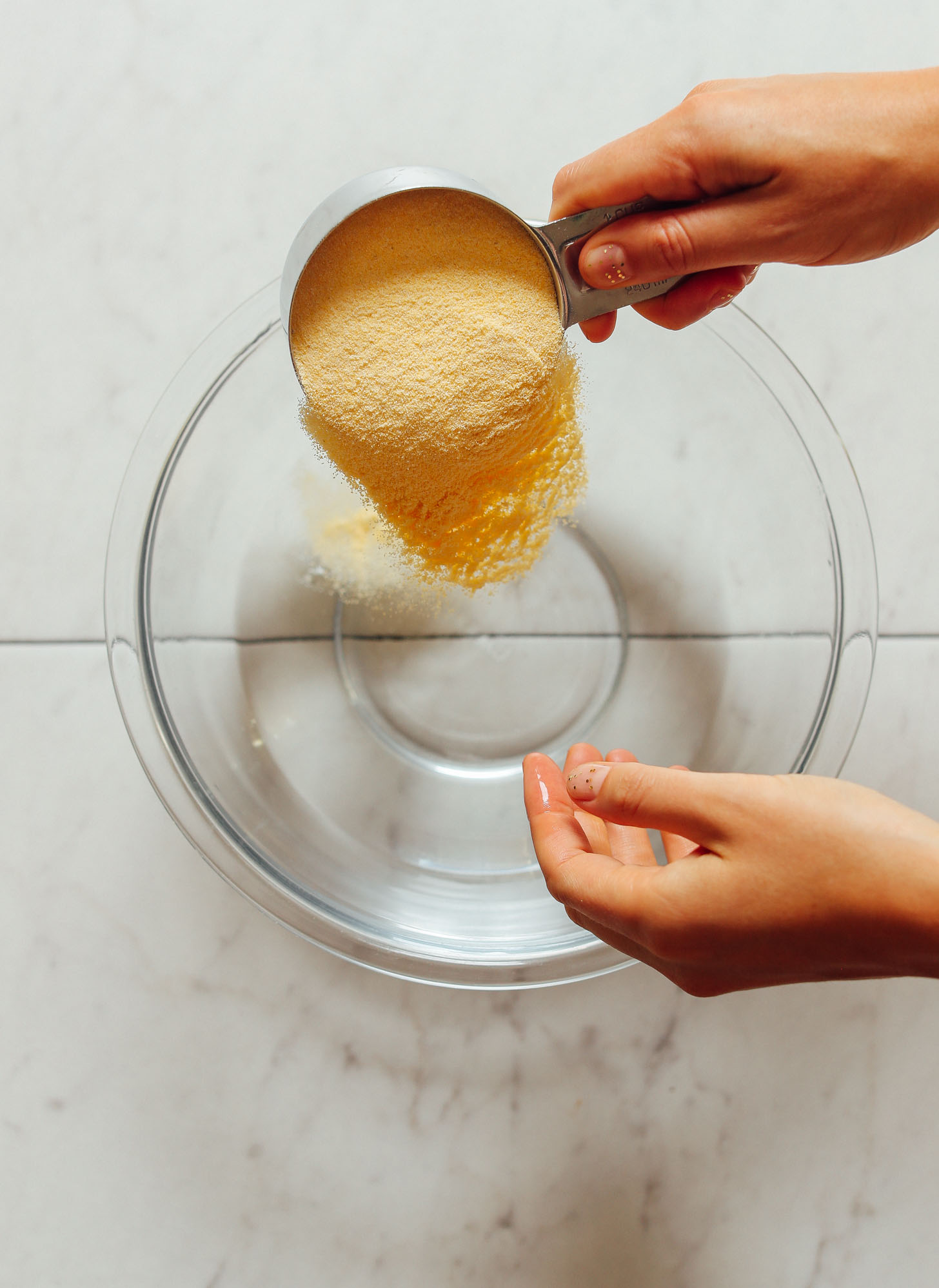 Pouring areparina into a bowl for homemade Arepas
