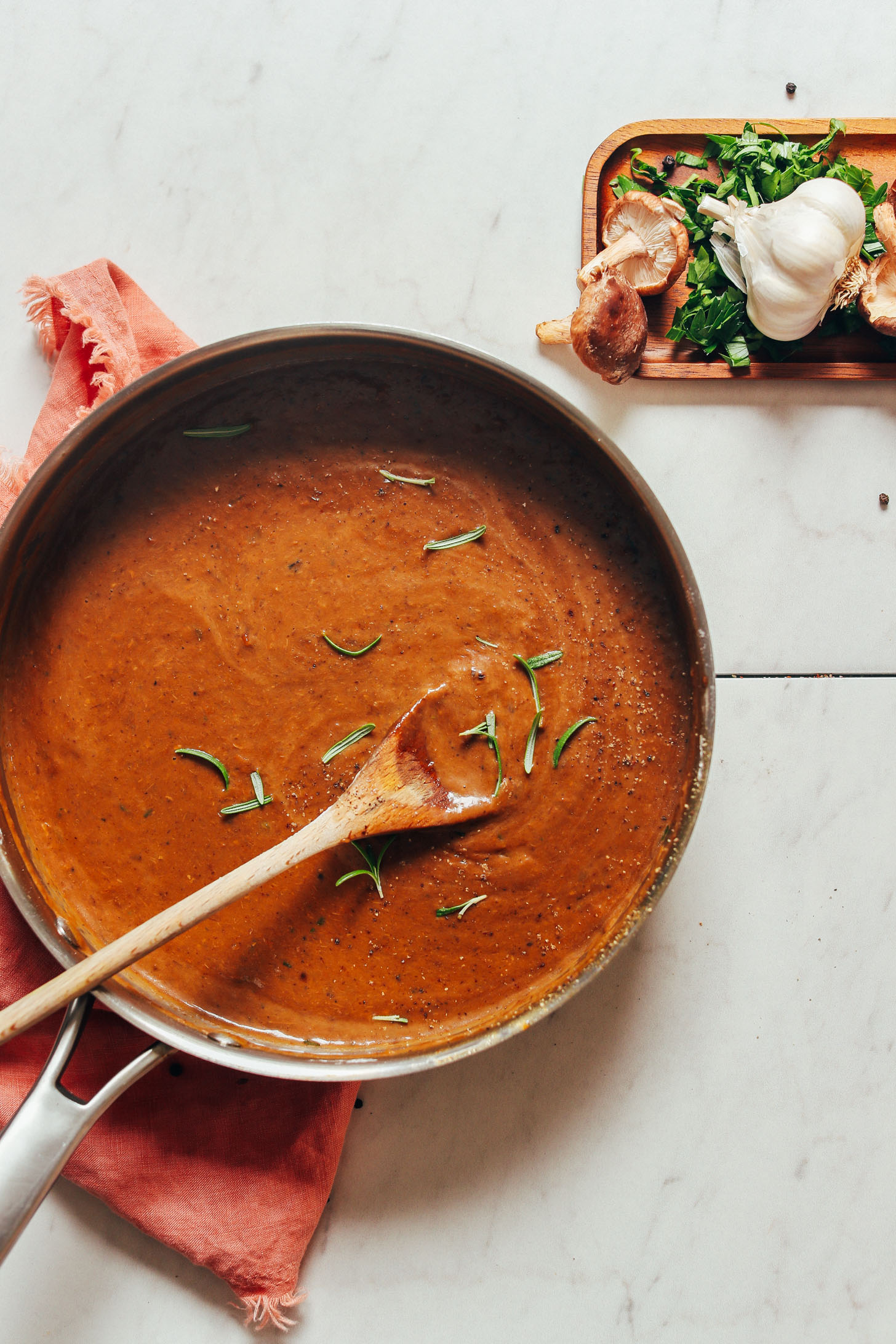 Cooking vegan porcini mushroom gravy in a large skillet