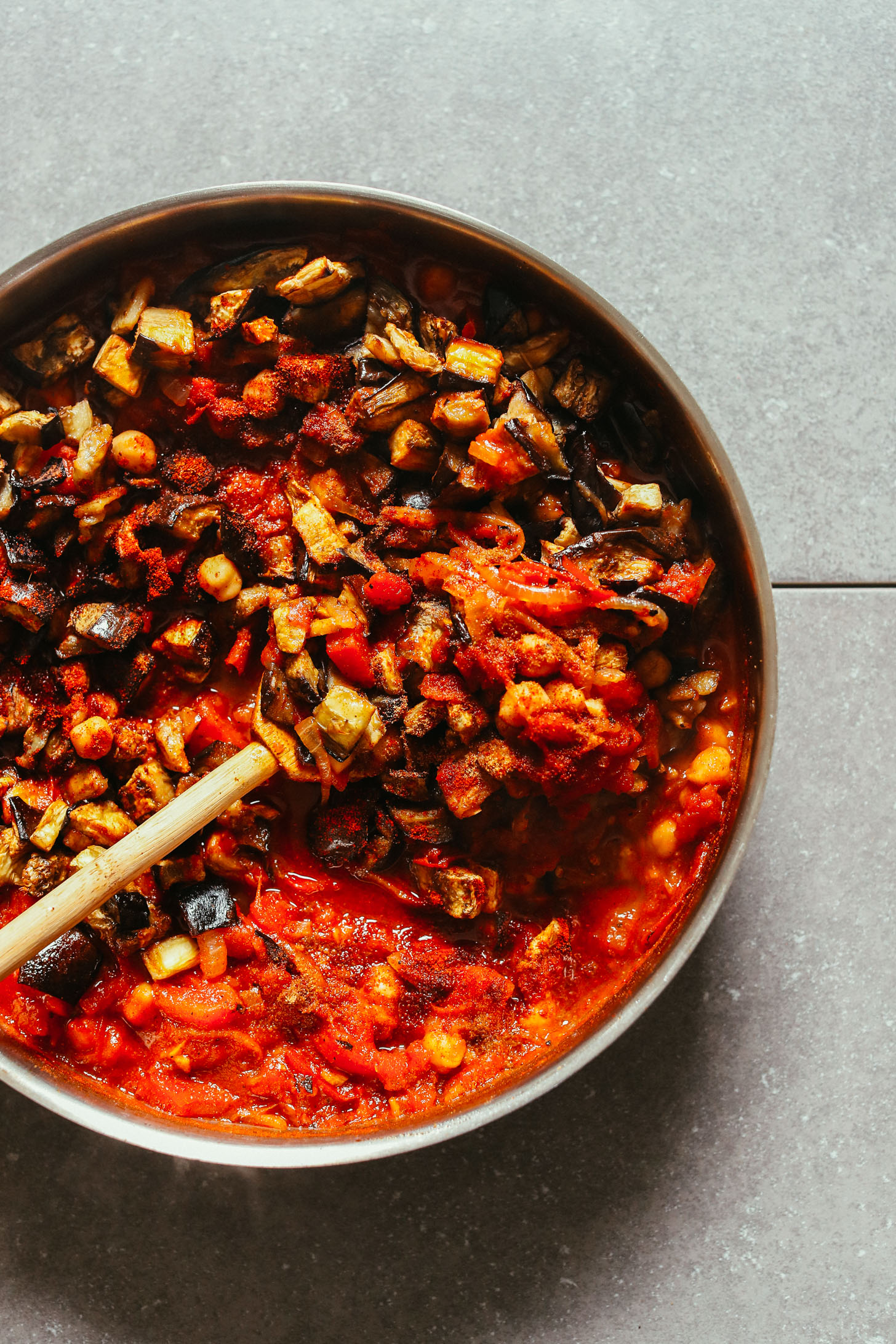 Cooking Moroccan-Spiced Roasted Eggplant & Tomato Stew in a large skillet