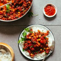 Plate and sauté pan filled with our Moroccan-Spiced Roasted Eggplant & Tomato Stew