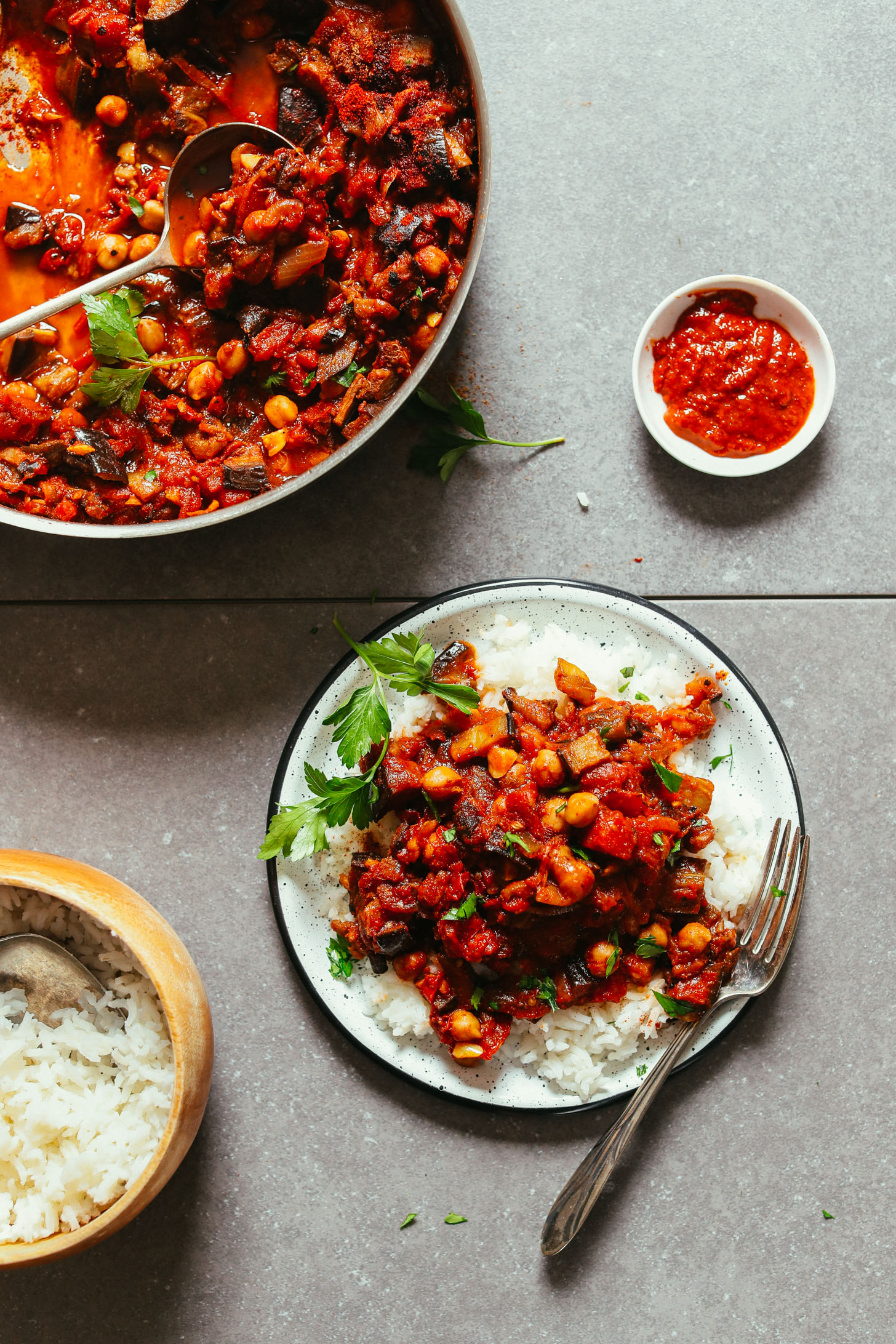 Skillet and plate of Moroccan-Spiced Roasted Eggplant & Tomato Stew