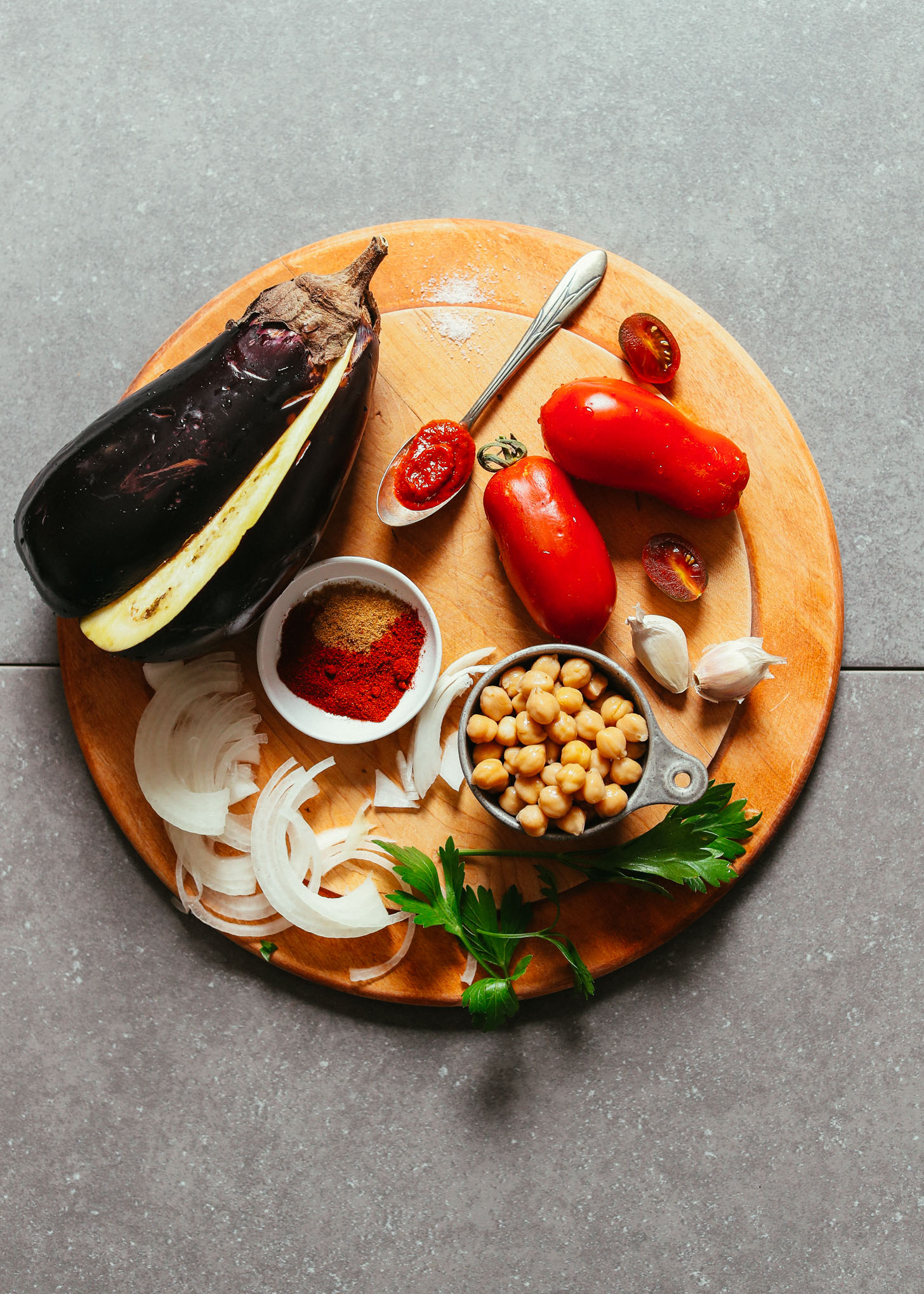 Wood cutting board and other ingredients for making Moroccan-Spiced Eggplant & Tomato Stew