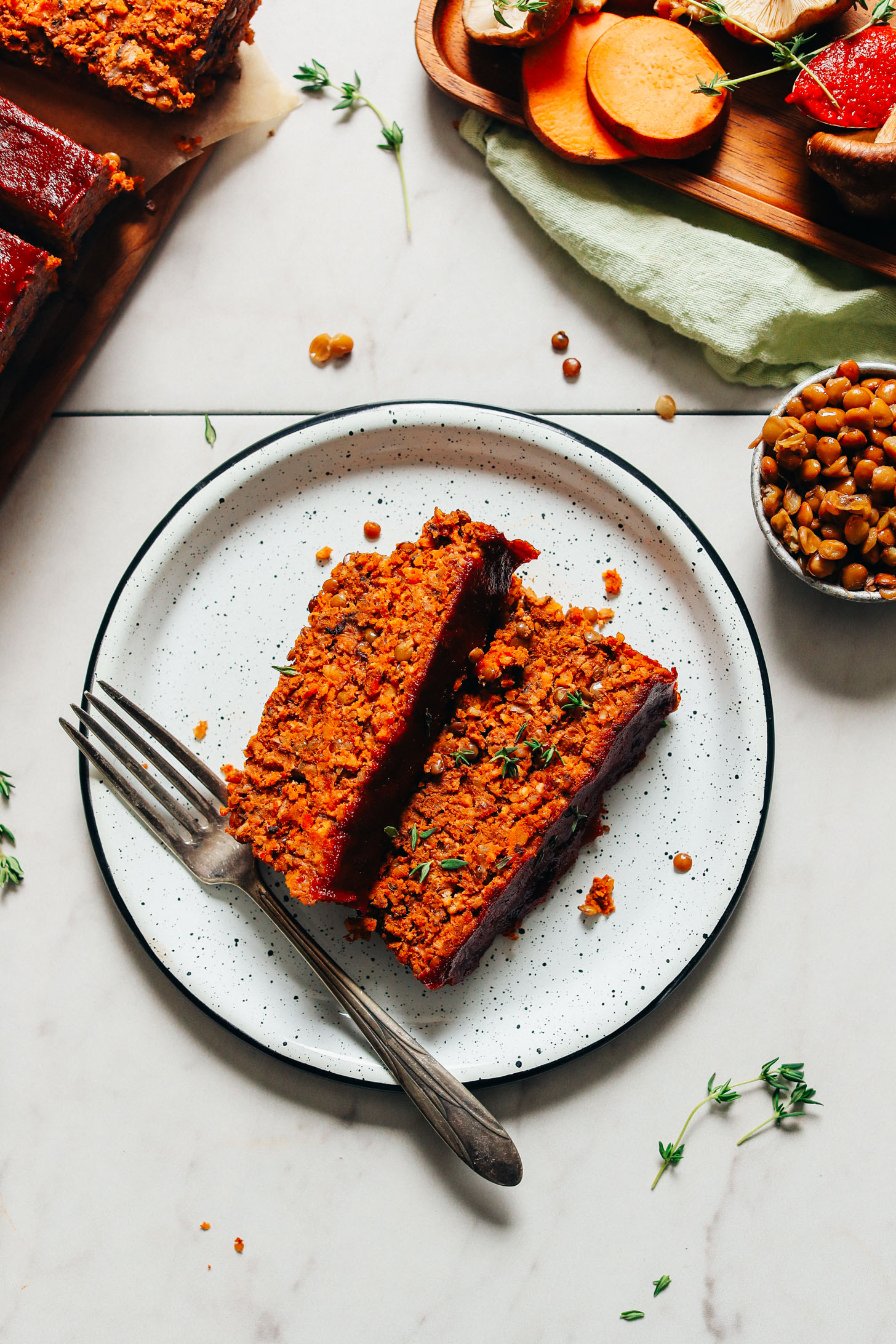 White enameled plate with two slices of Vegan Lentil Meatloaf