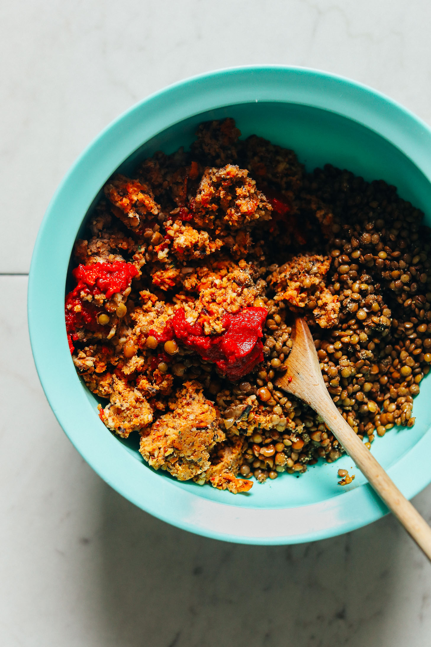 Mixing lentils into other ingredients for Vegan Thanksgiving Meatloaf