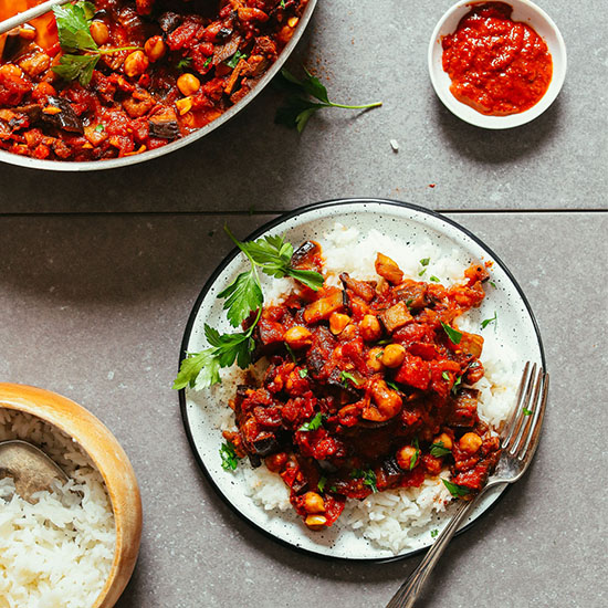 Plate of Moroccan Eggplant Tomato Stew with fresh parsley served over white rice