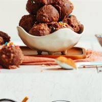 Plates and bowl of No-Bake Fudgy Chocolate Cake Bites