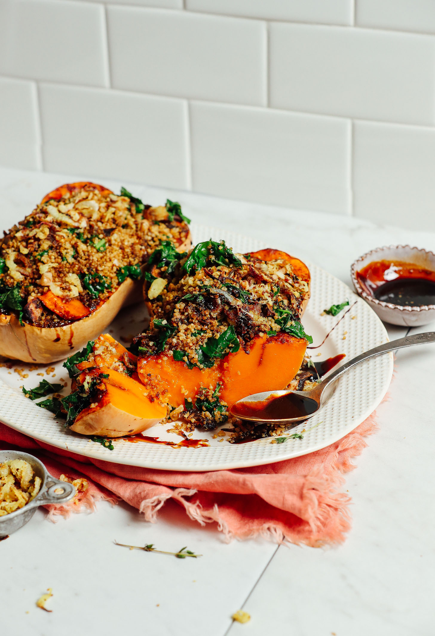 White platter filled with vegan Stuffed Butternut Squash for Thanksgiving