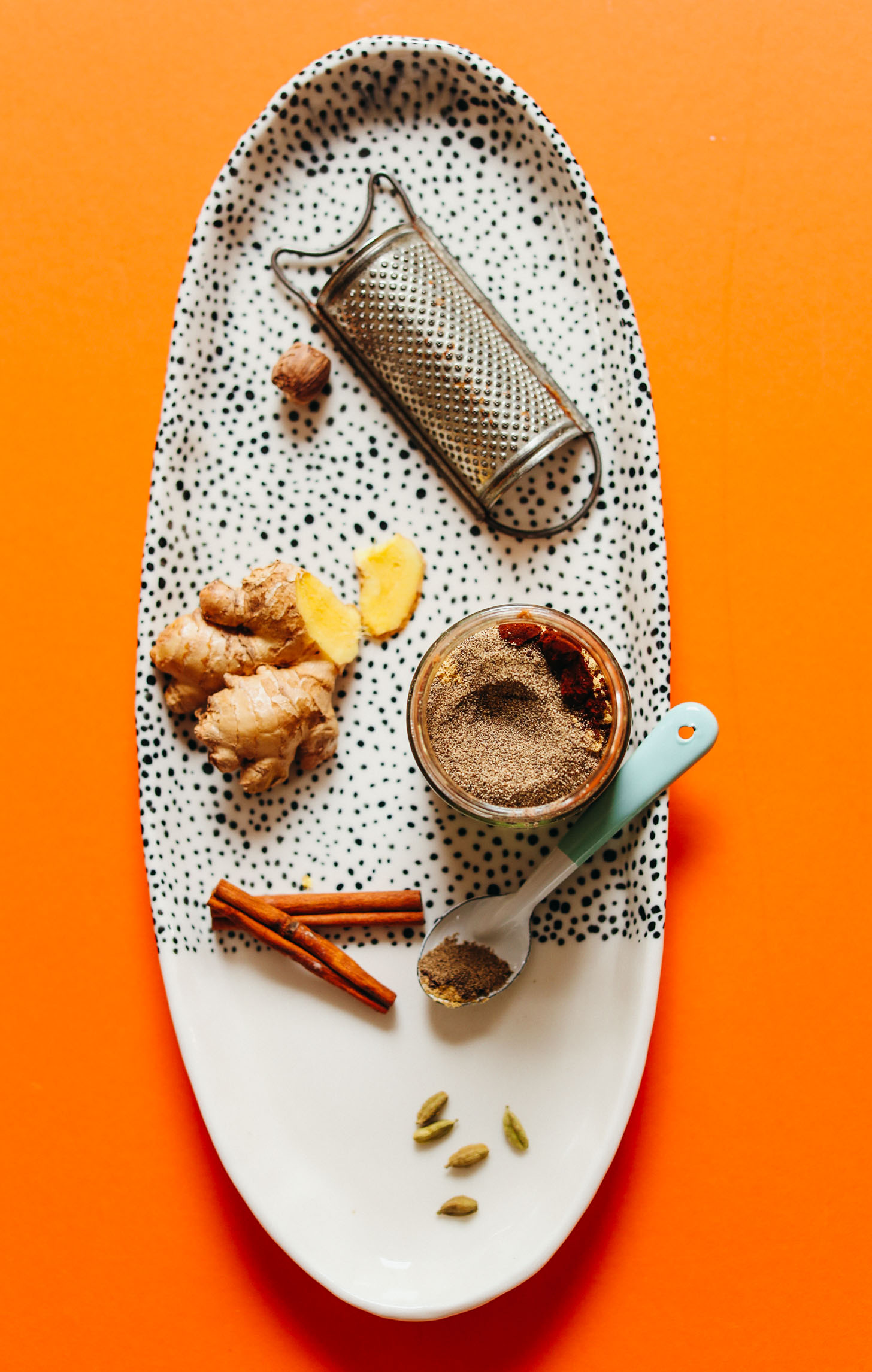 Platter of ingredients and jar of homemade caffeine free chai mix